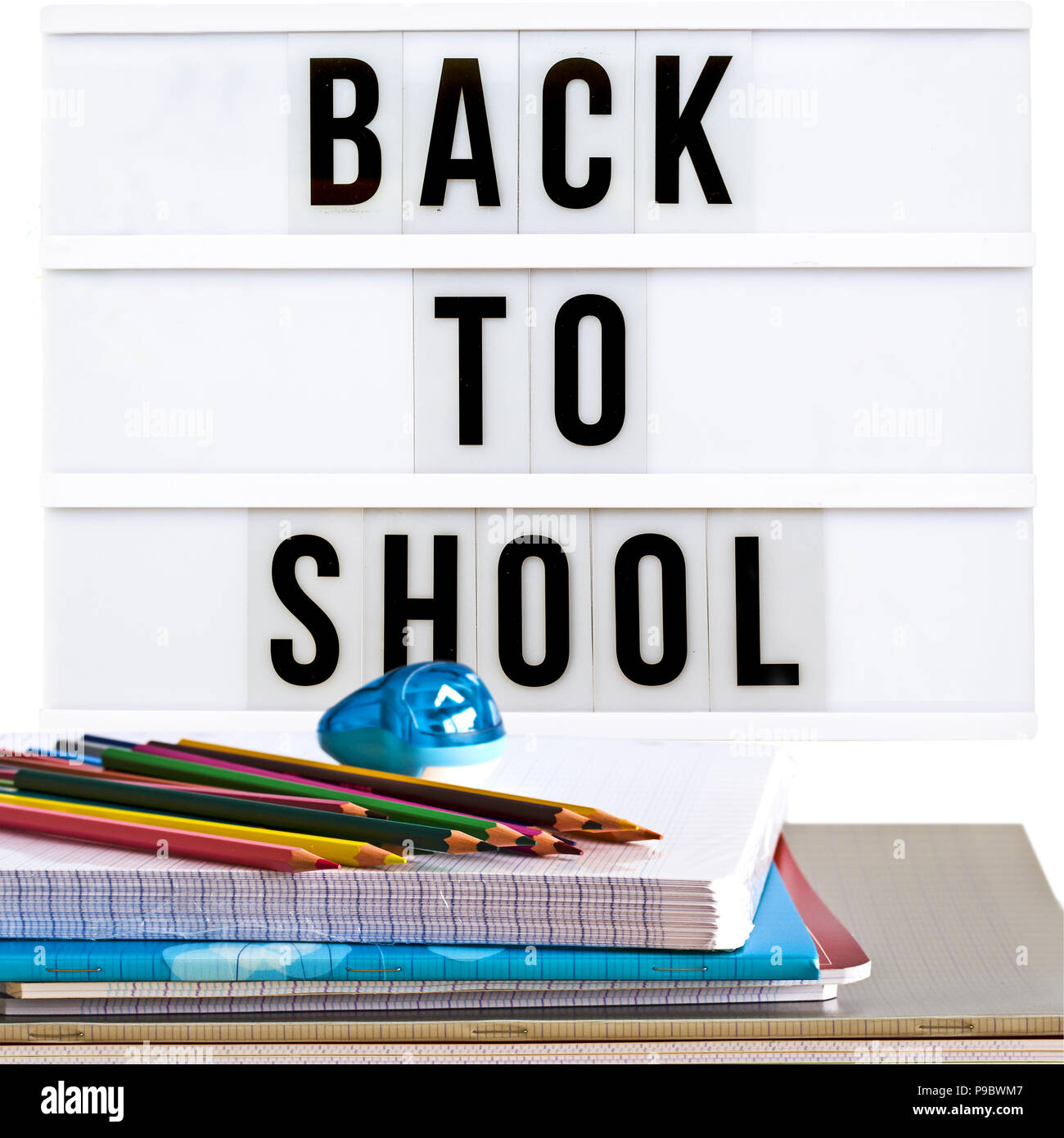 Back to school written in a light box with school supplies Stock Photo