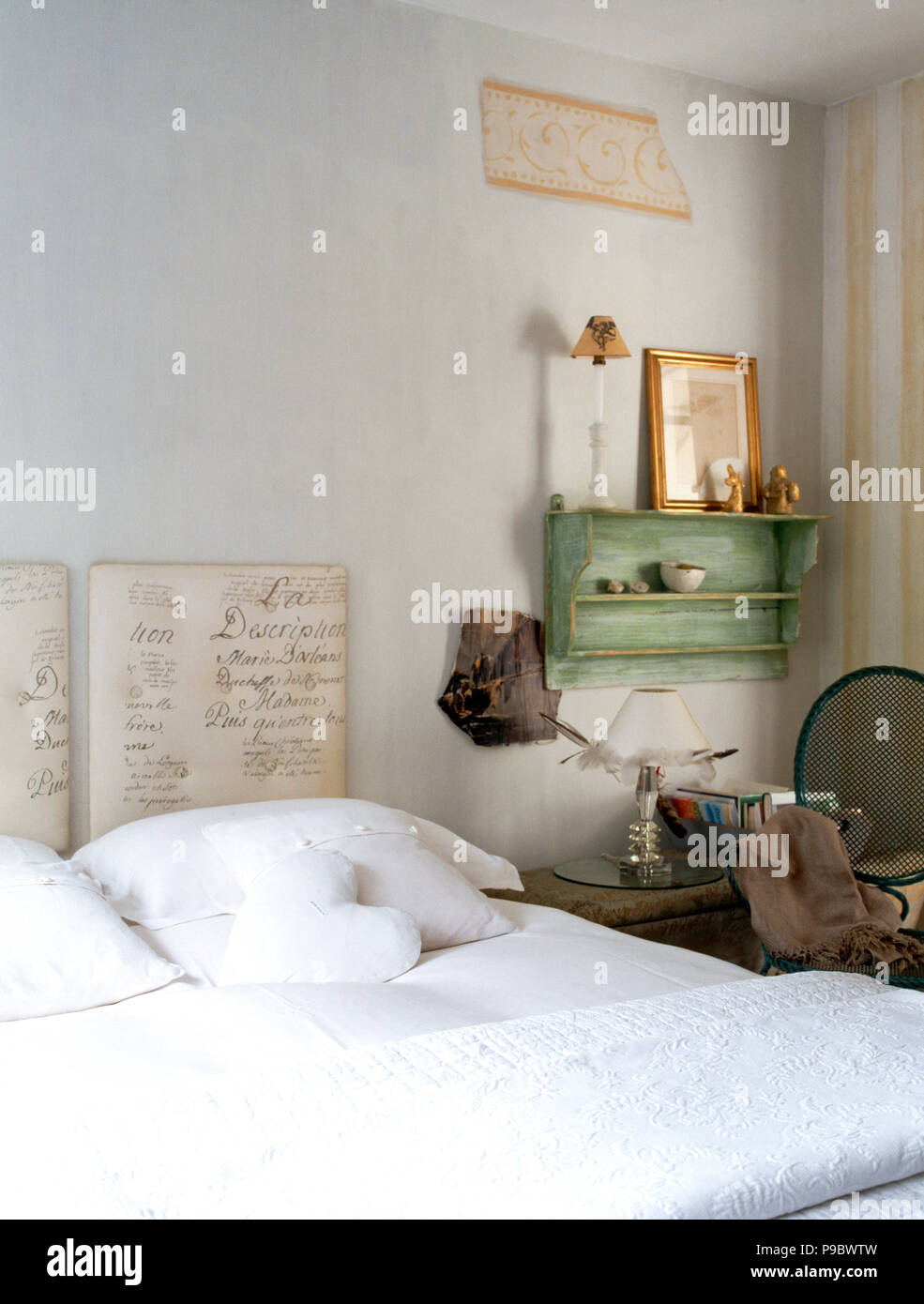 Bed with upholstered headboard with writing script pattern Stock Photo
