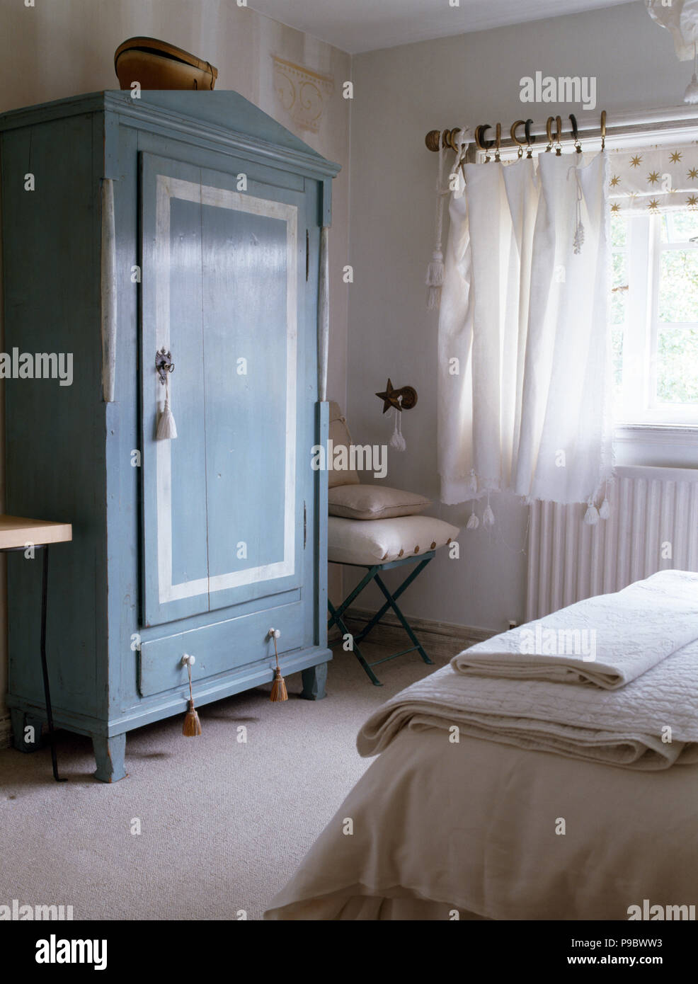 Blue Painted Wardrobe In A Cottage Bedroom With White Voile