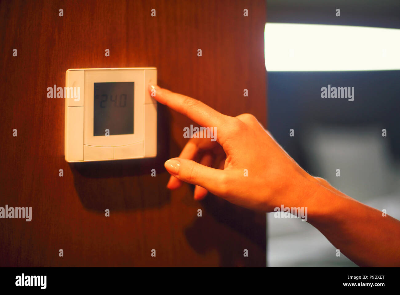 Hand turning on digital climate control. Close up Stock Photo Alamy