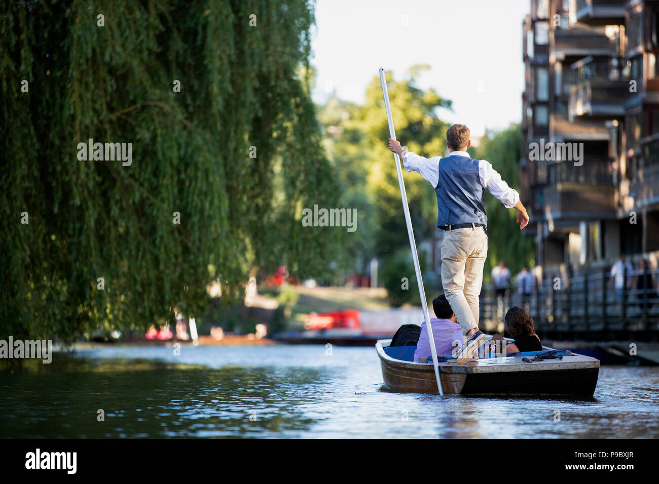 A Punt chauffeur makes their way up the River Cam in Cambridge England. Stock Photo