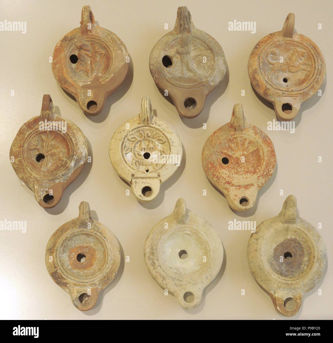 Oil lamps. Clay. Some central discus ornamented with motif in low relief. 2nd century. Spain. National Archaeological Museum. Tarragona. Spain. Stock Photo