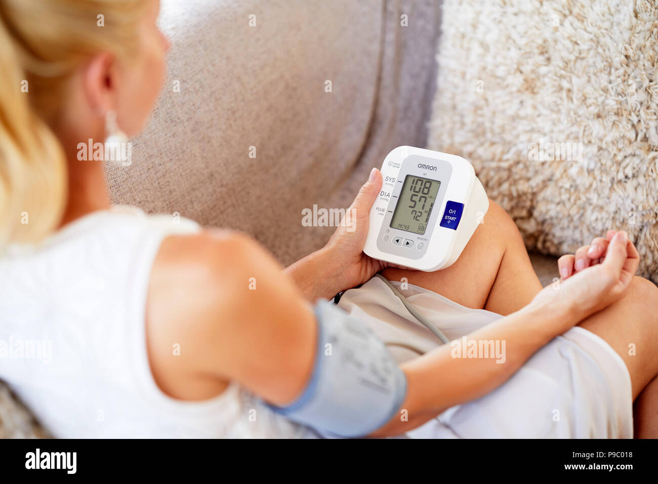 Woman checking her blood pressure Stock Photo