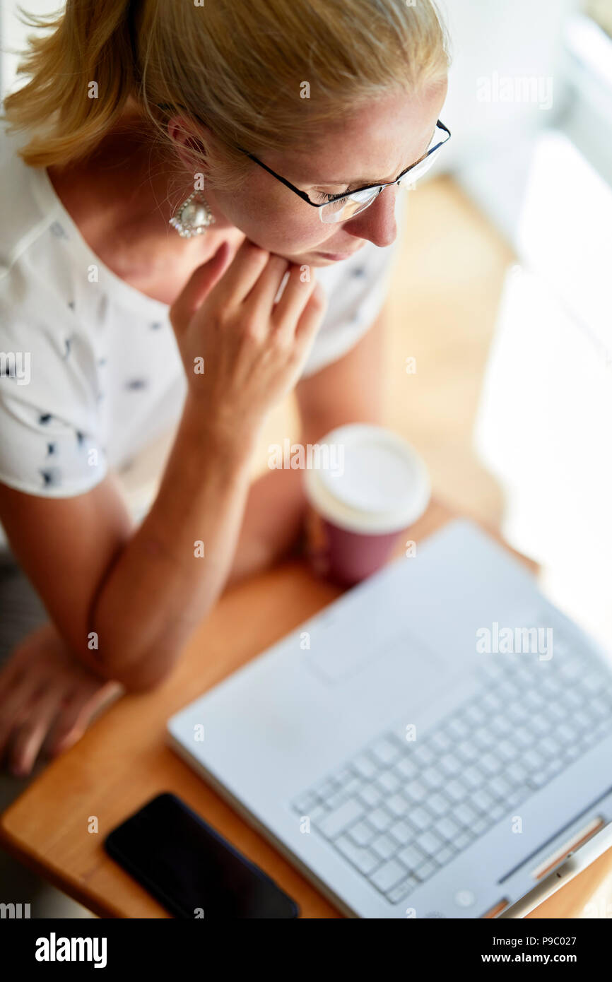 Woman using laptop online Stock Photo