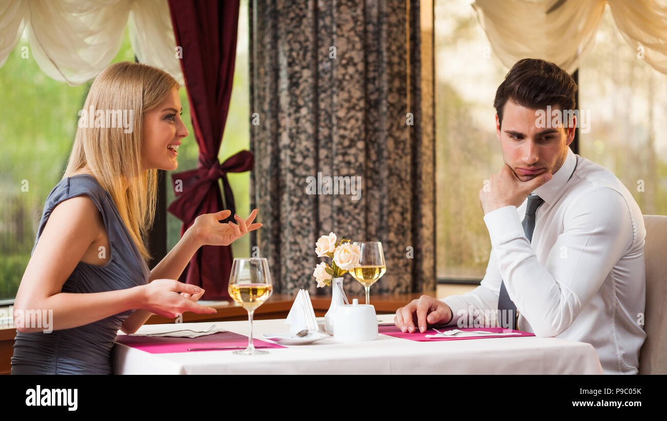 Man is getting bored on first date Stock Photo