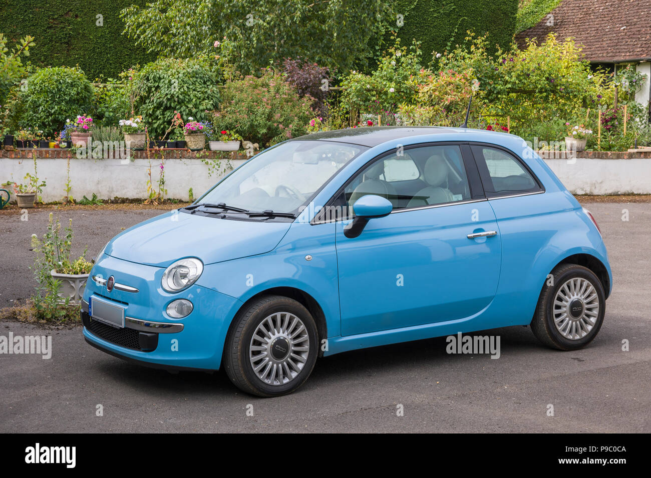 Side view of Fiat 500 mini car in UK with identification number plate partly obscured for security reasons Stock Photo