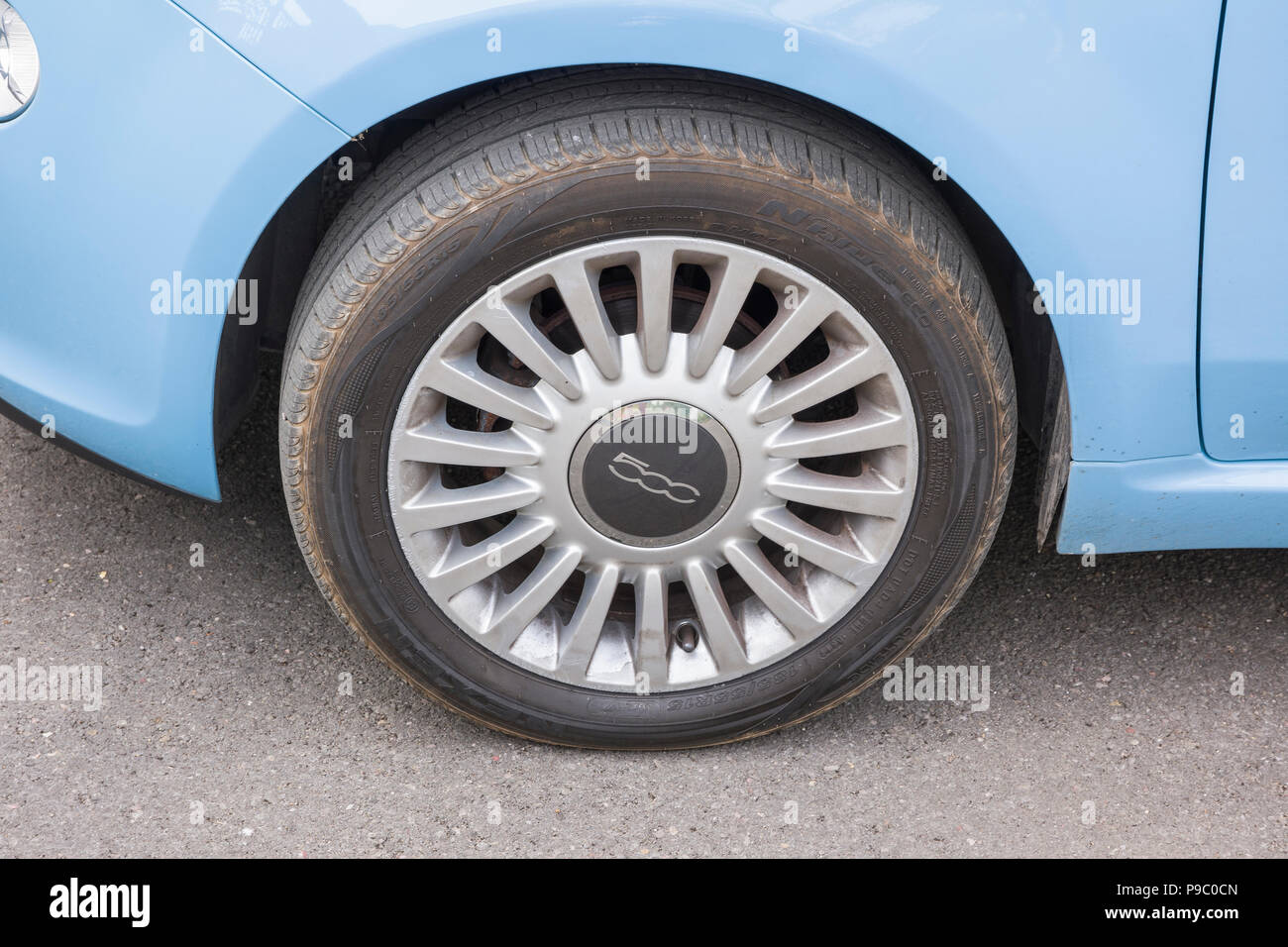 Wheel on a small Fiat 500 mini-car bearing the numerical model number on the wheel hub in UK Stock Photo