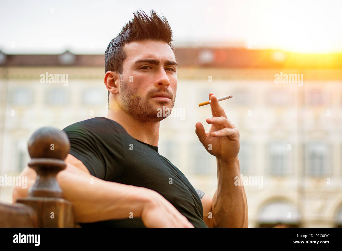 Handsome masculine man smoking Stock Photo