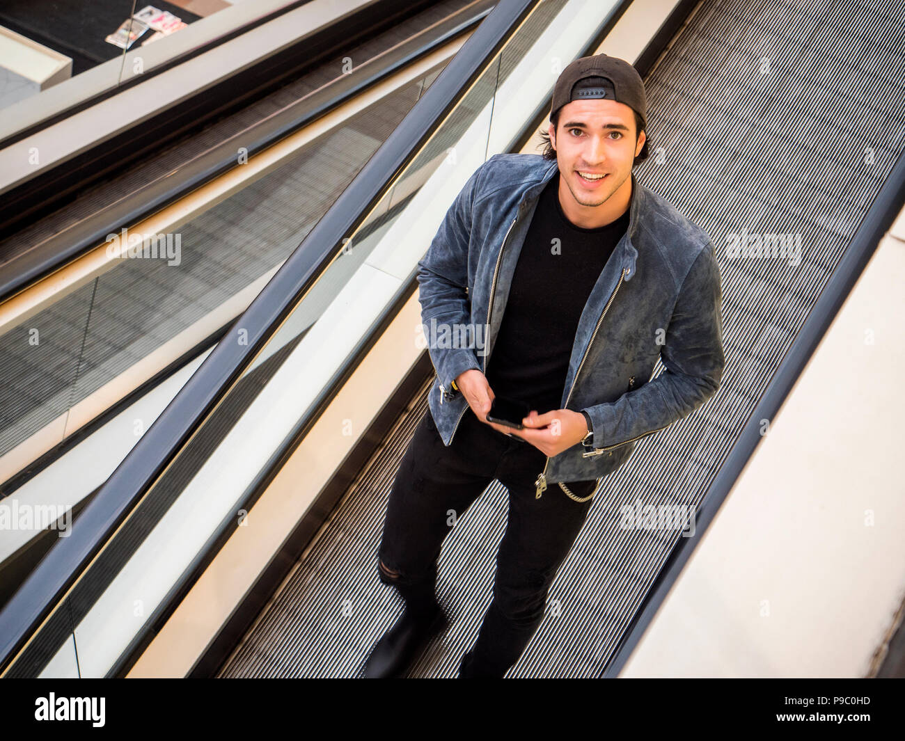 Young man on moving walkway or travellator Stock Photo