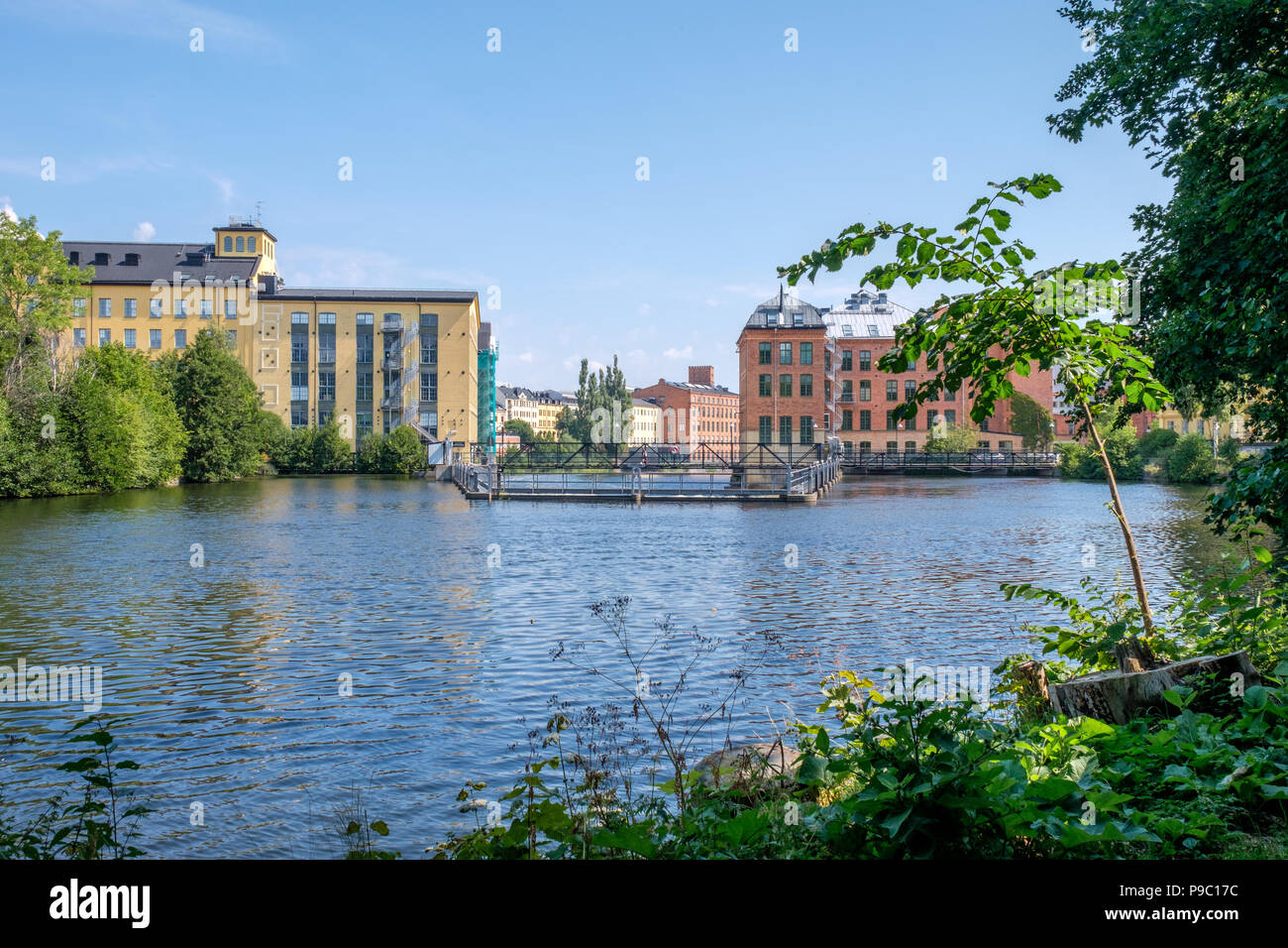 Motala river and the industrial landscape during summer in Norrkoping. Norrkoping is a historic industrial town in Sweden. Stock Photo