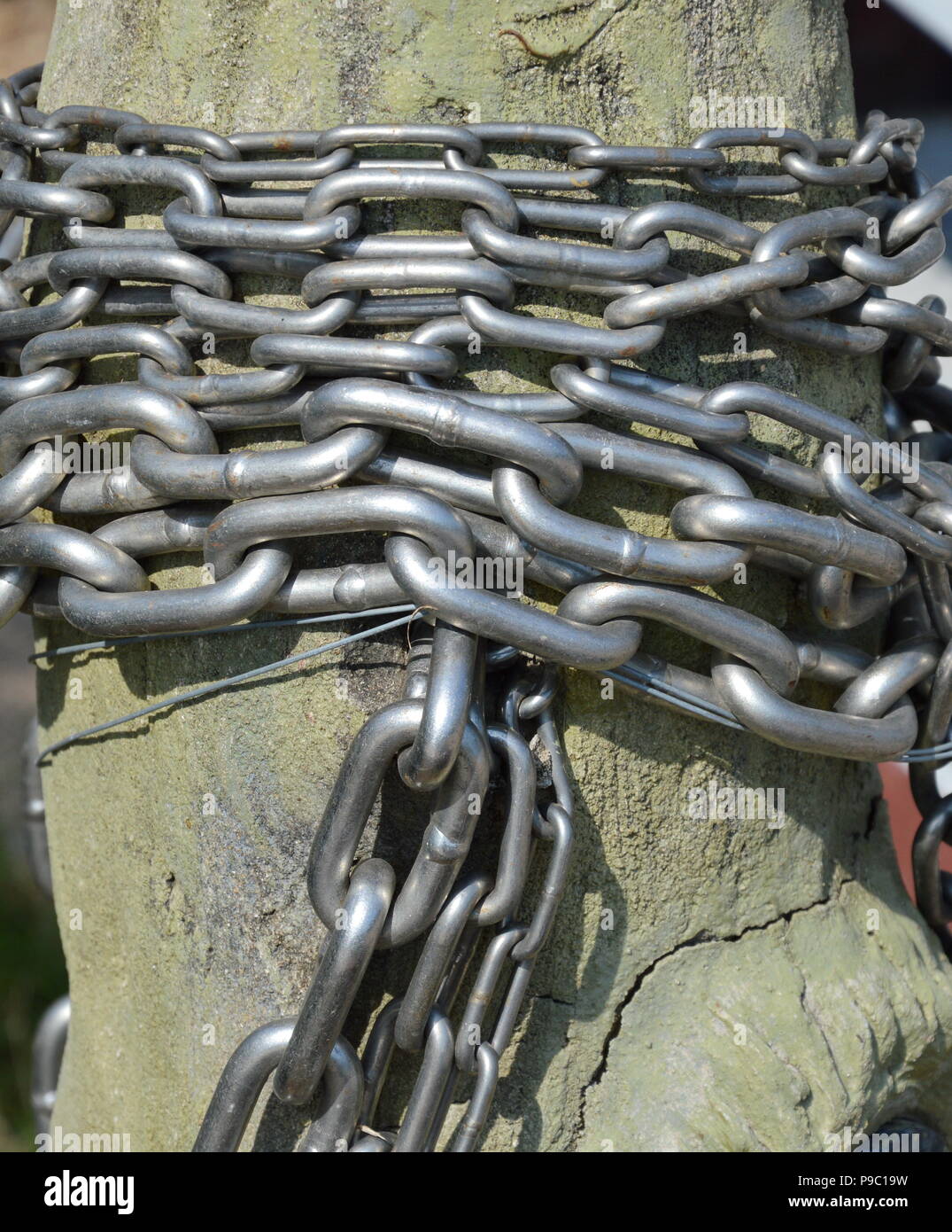 iron chain roll over wooden pole Stock Photo Alamy