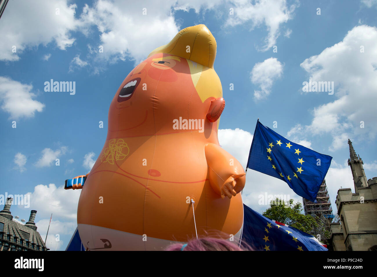 July 13th 2018.Central London. Demonstration against the visit of US President Donald Trump to England. A small blow up Trump effigy in Parliament Squ Stock Photo