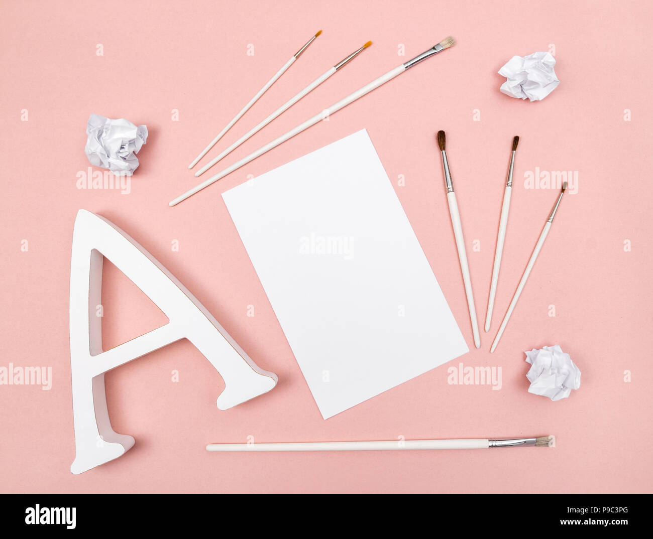 Arts and creativity. Letter A, paintbrushes and blank paper, on pastel