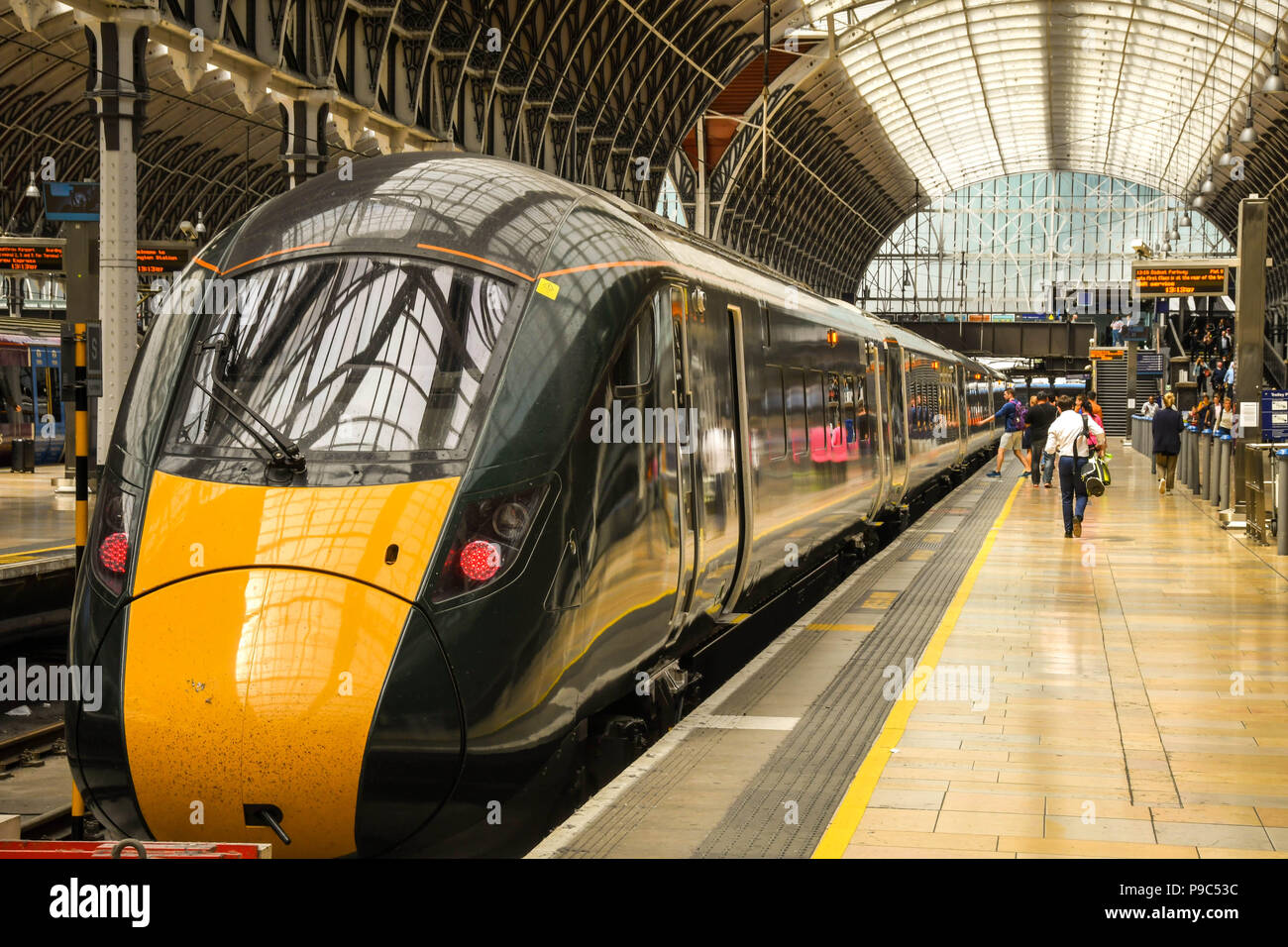 New Class 800 electro diesel train in London Paddington railway station with people on the platform. It is operated by Great Western Railway Stock Photo