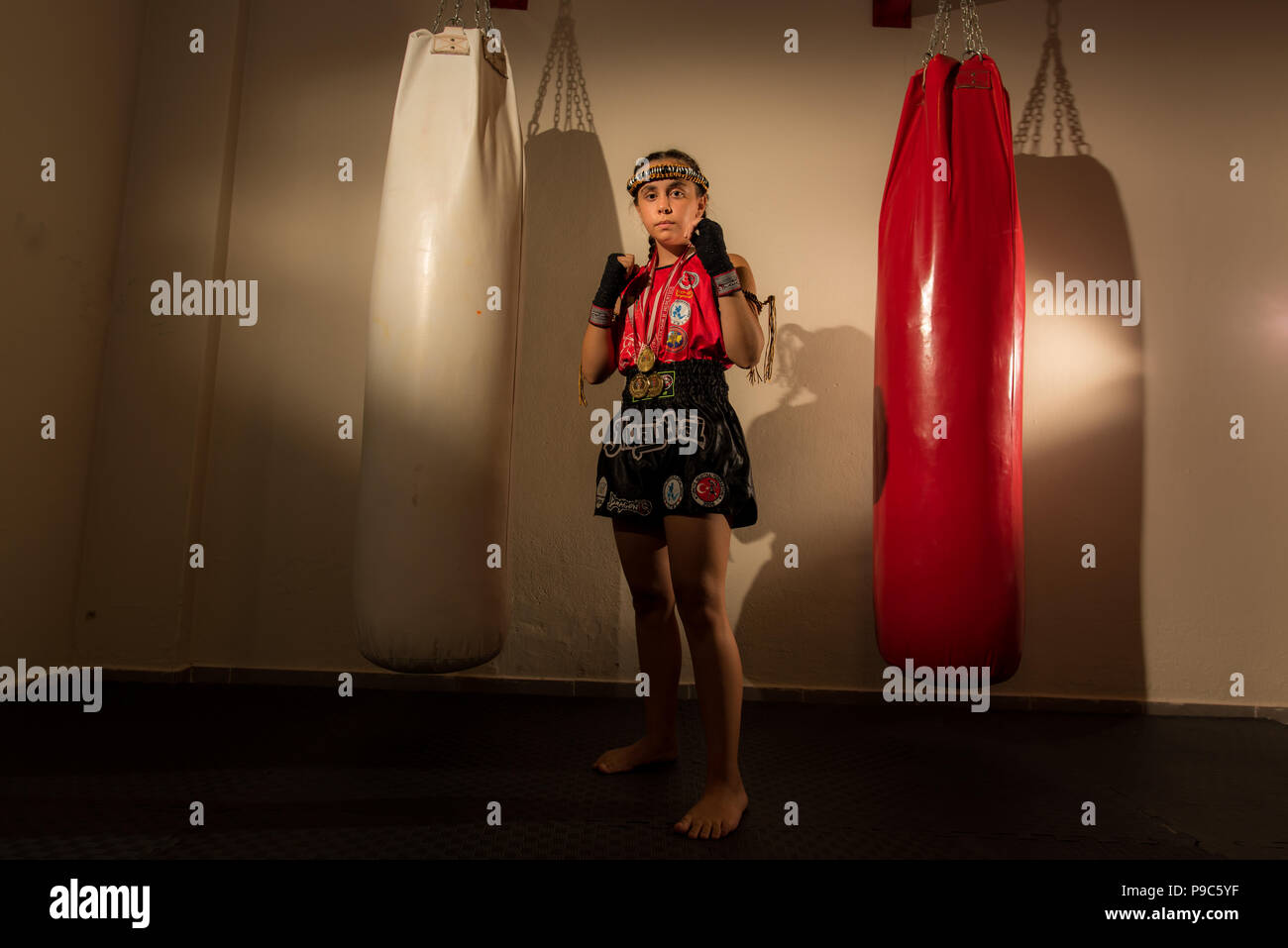 Young girl female junior kick boxer Muay Thai MMA boxing fighter Stock Photo