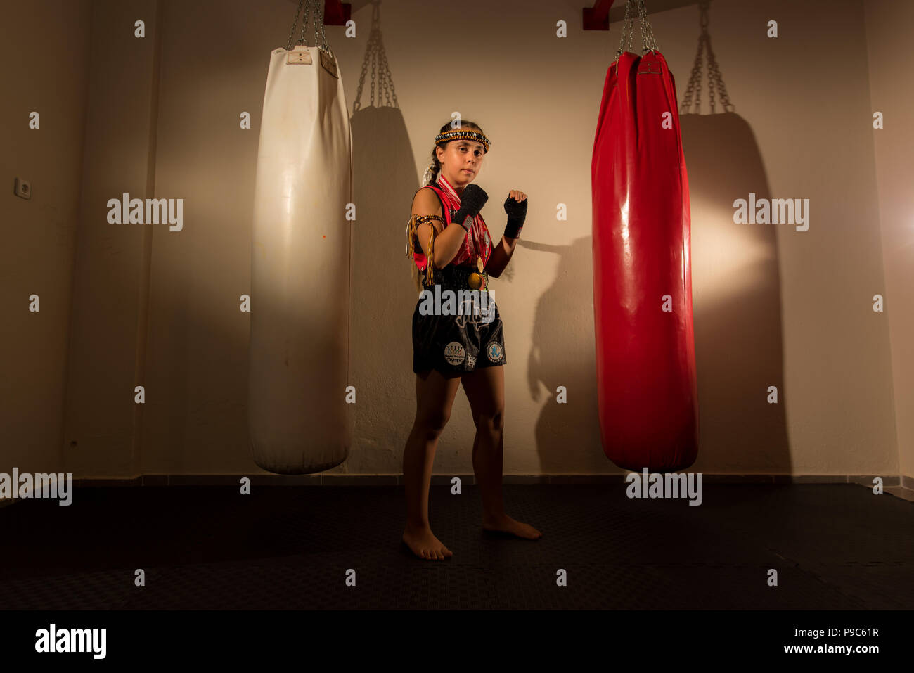 Young girl female junior kick boxer Muay Thai MMA boxing fighter Stock Photo