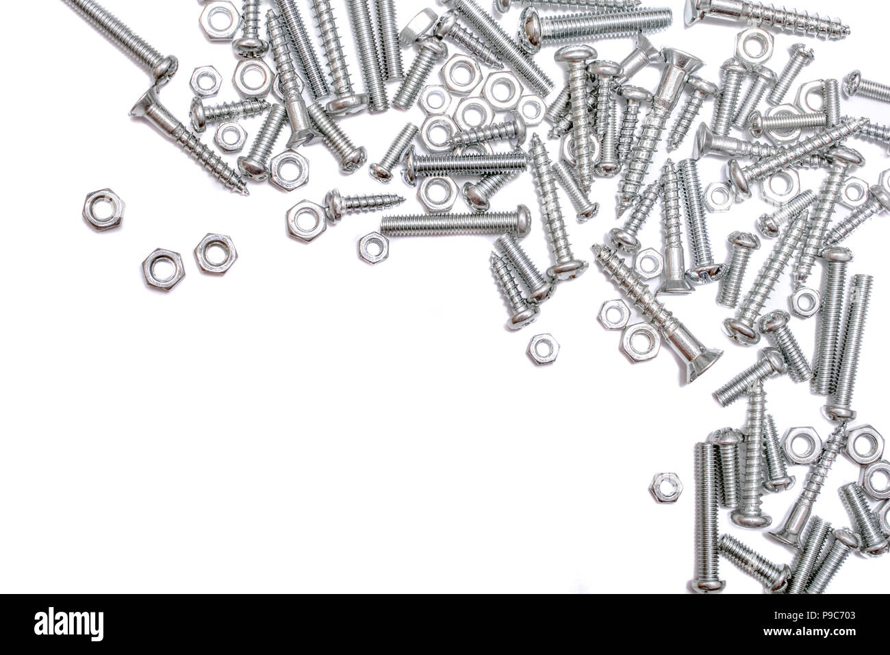 Collection Of Iron Screws, Wood Screws and Bolts At The Right and Top Border Of A Whitebox Stock Photo