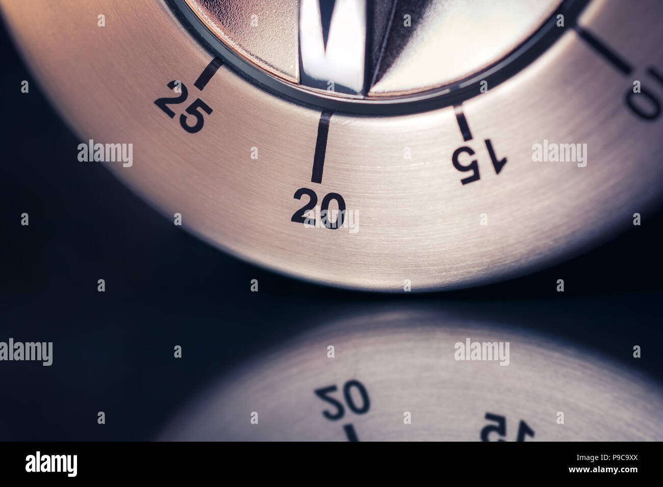 https://c8.alamy.com/comp/P9C9XX/20-minutes-macro-of-an-analog-chrome-kitchen-timer-with-dark-background-and-reflection-P9C9XX.jpg