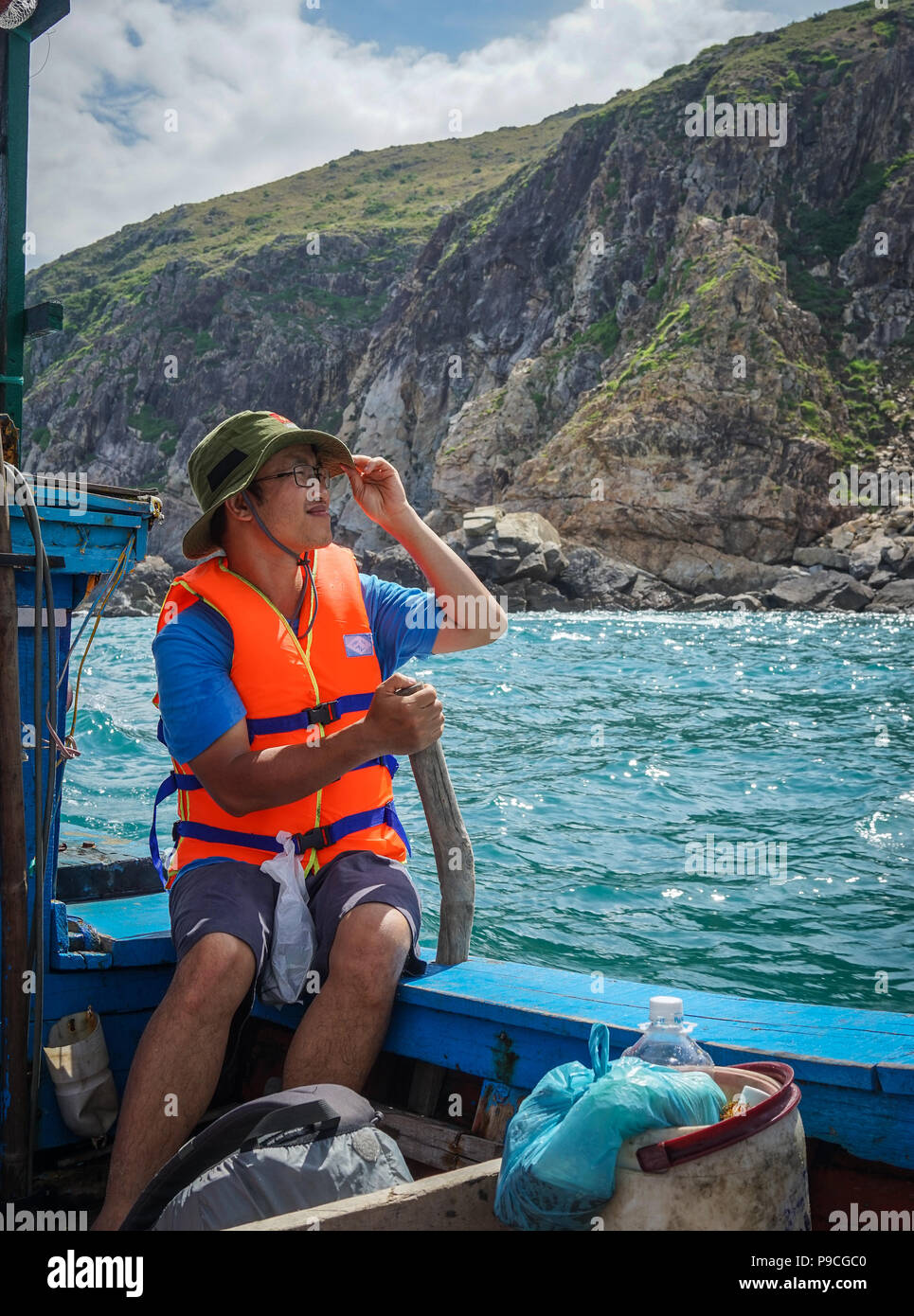 Nha Trang, Vietnam - Oct 11, 2015. A man sitting on boat and looking at ...