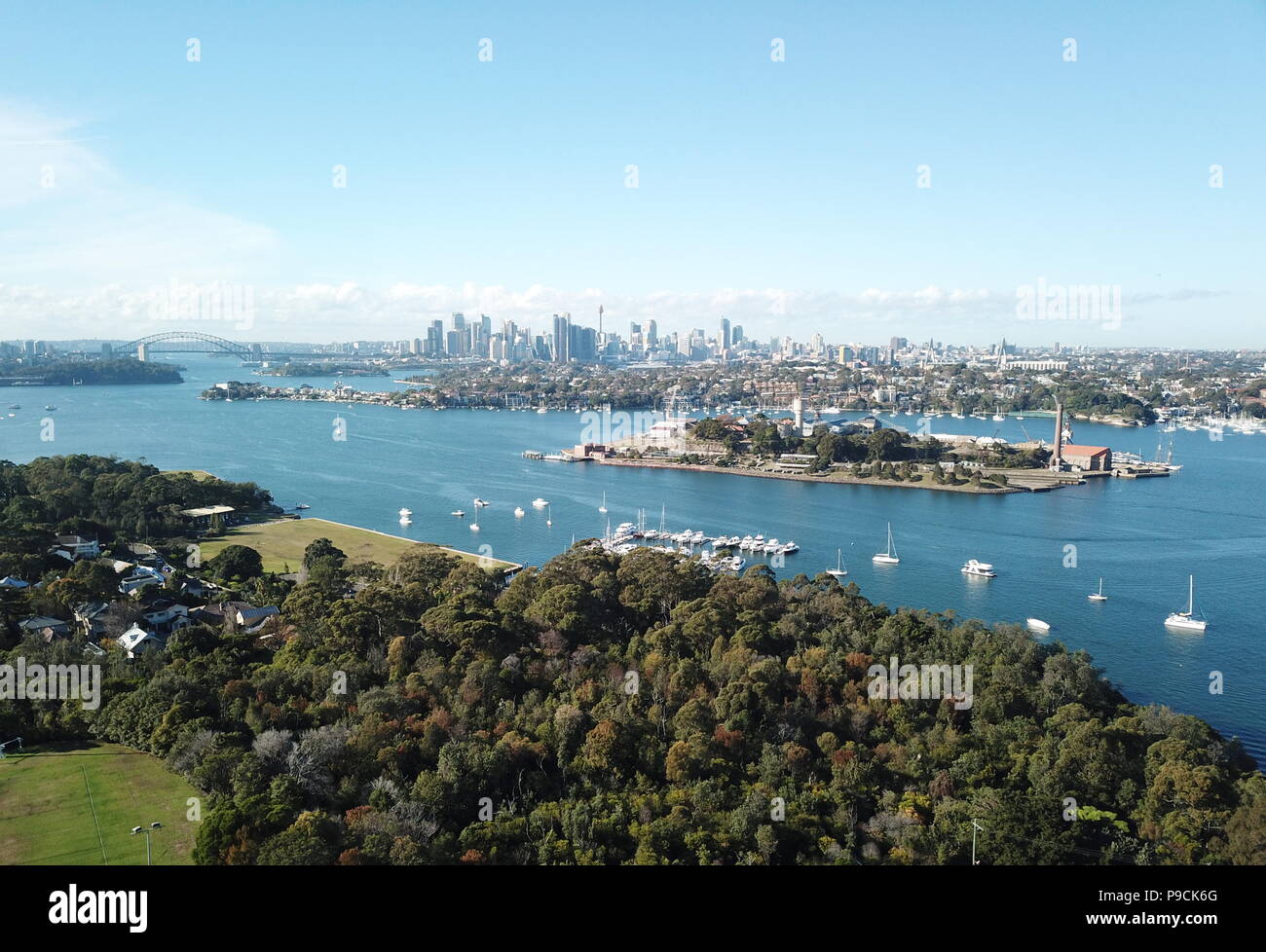 Aerial view of Cockatoo Island, Sydney CBD and Harbour Bridge with Sydney tower and financial district skyscrapers. Stock Photo