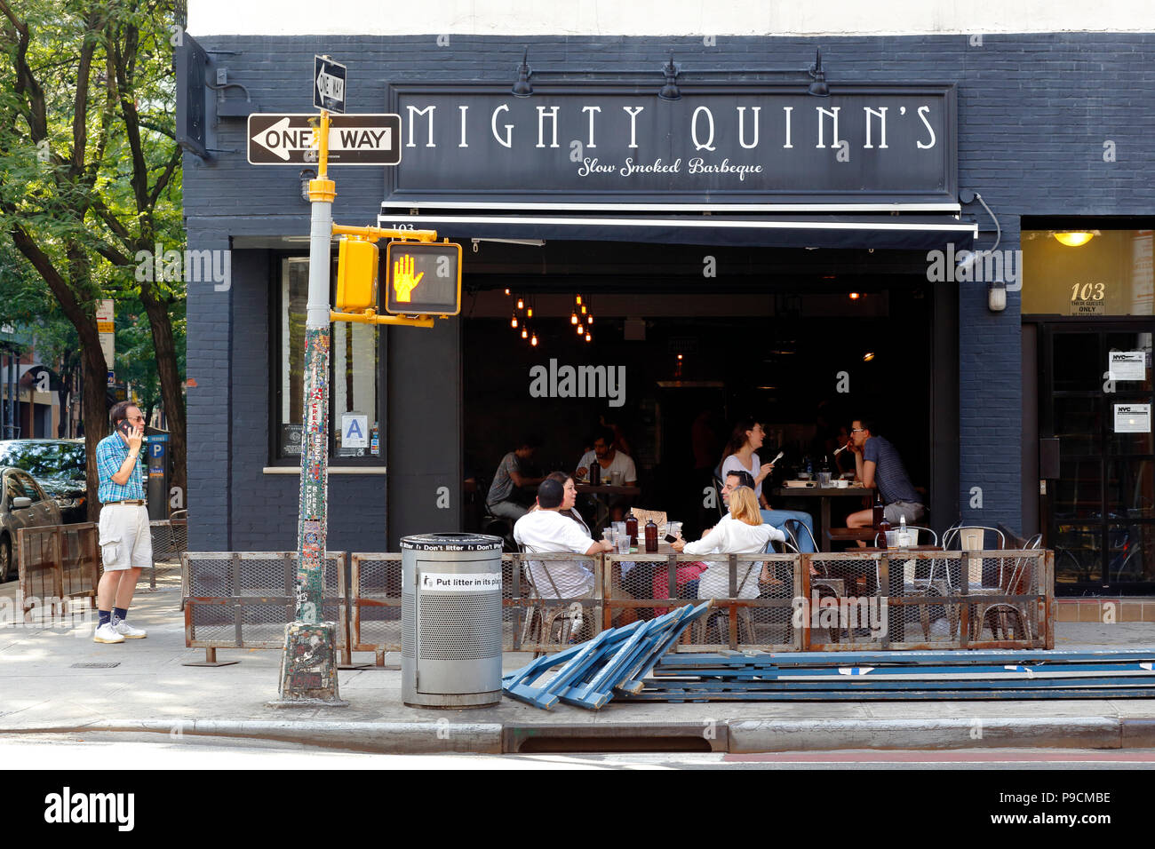 Mighty Quinn's Barbeque, 103 Second Ave, New York, NY. exterior storefront of a BBQ eatery, and sidewalk cafe in the East Village of Manhattan. Stock Photo