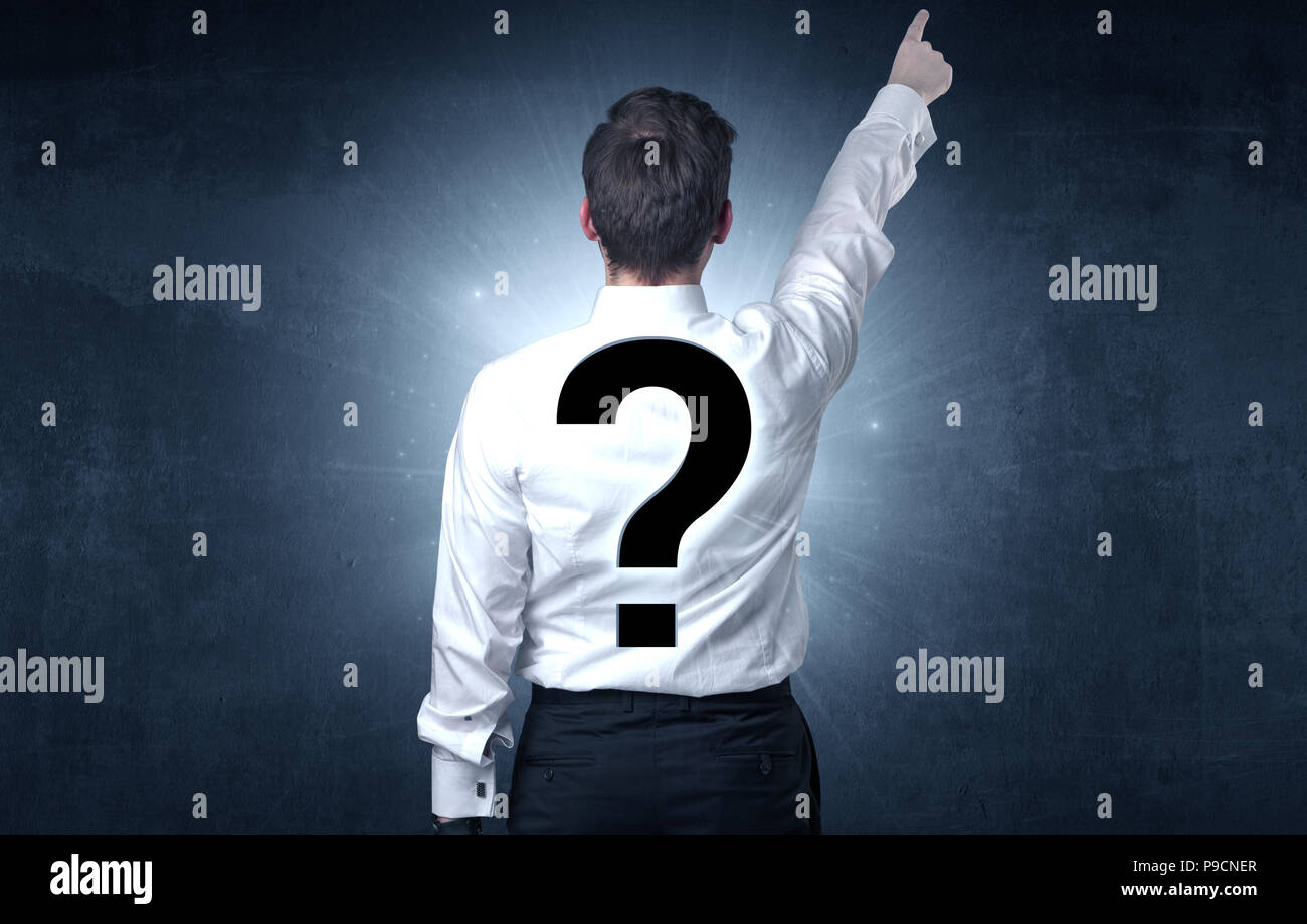 Businessman standing and thinking about questions Stock Photo - Alamy