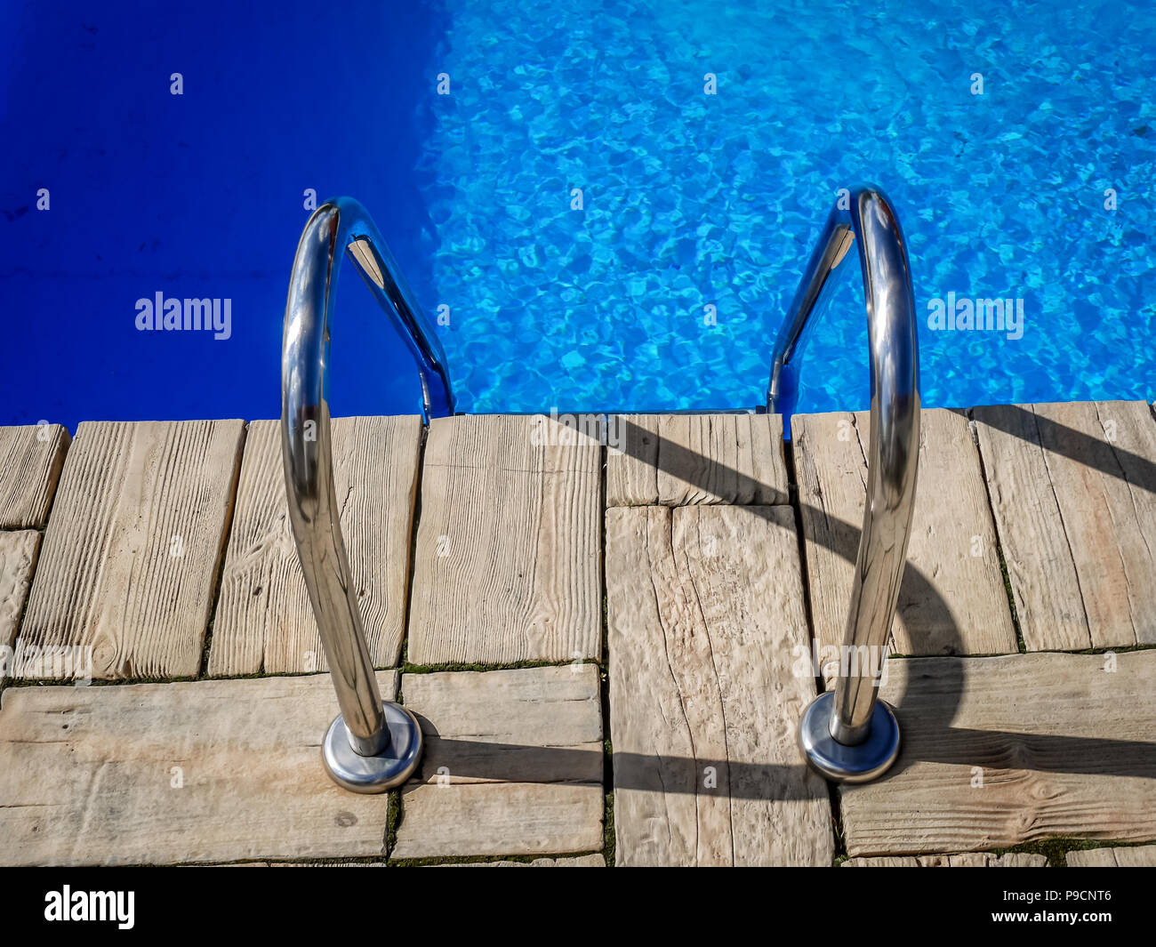 Steel handle bars of the swimming pool Stock Photo