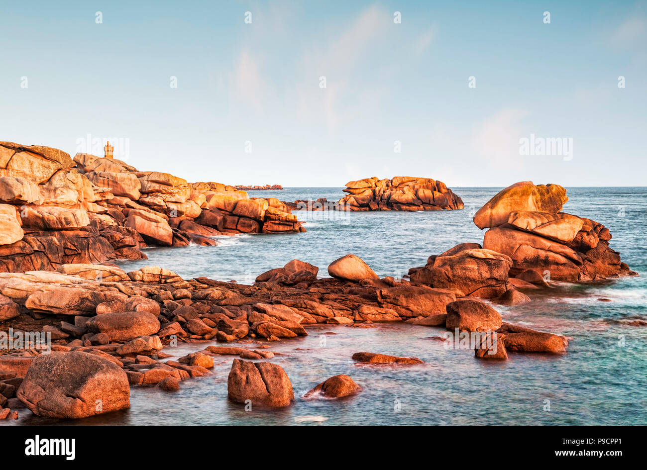 Pink Granite Coast and Ploumanach Lighthouse, on a clear morning before dawn. Stock Photo