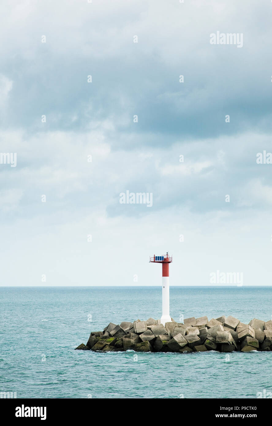 Solar powered Navigation beacon and man made harbour wall, Dunkirk, France, Europe Stock Photo