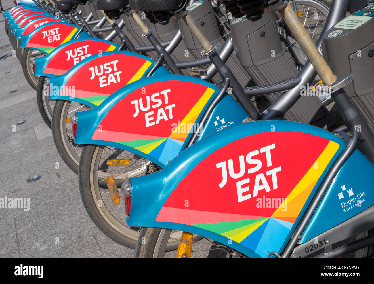 Just Eat logo sign on city bikes for hire in Dublin, Ireland, Europe Stock Photo