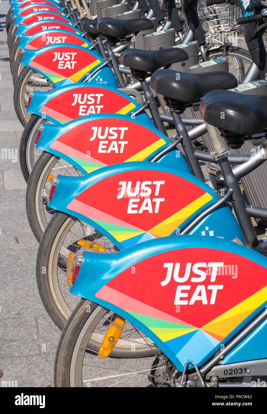 Just Eat logo sign on city bicycles for hire in Dublin, Ireland, Europe Stock Photo