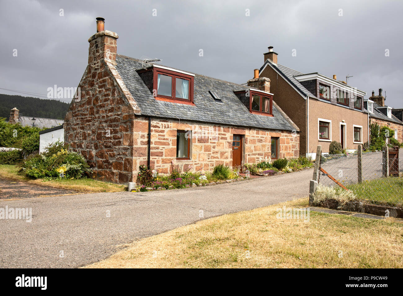 Traditional Simple Cottage in Golspie, Scotland.  The clouds are from storm Hector Stock Photo