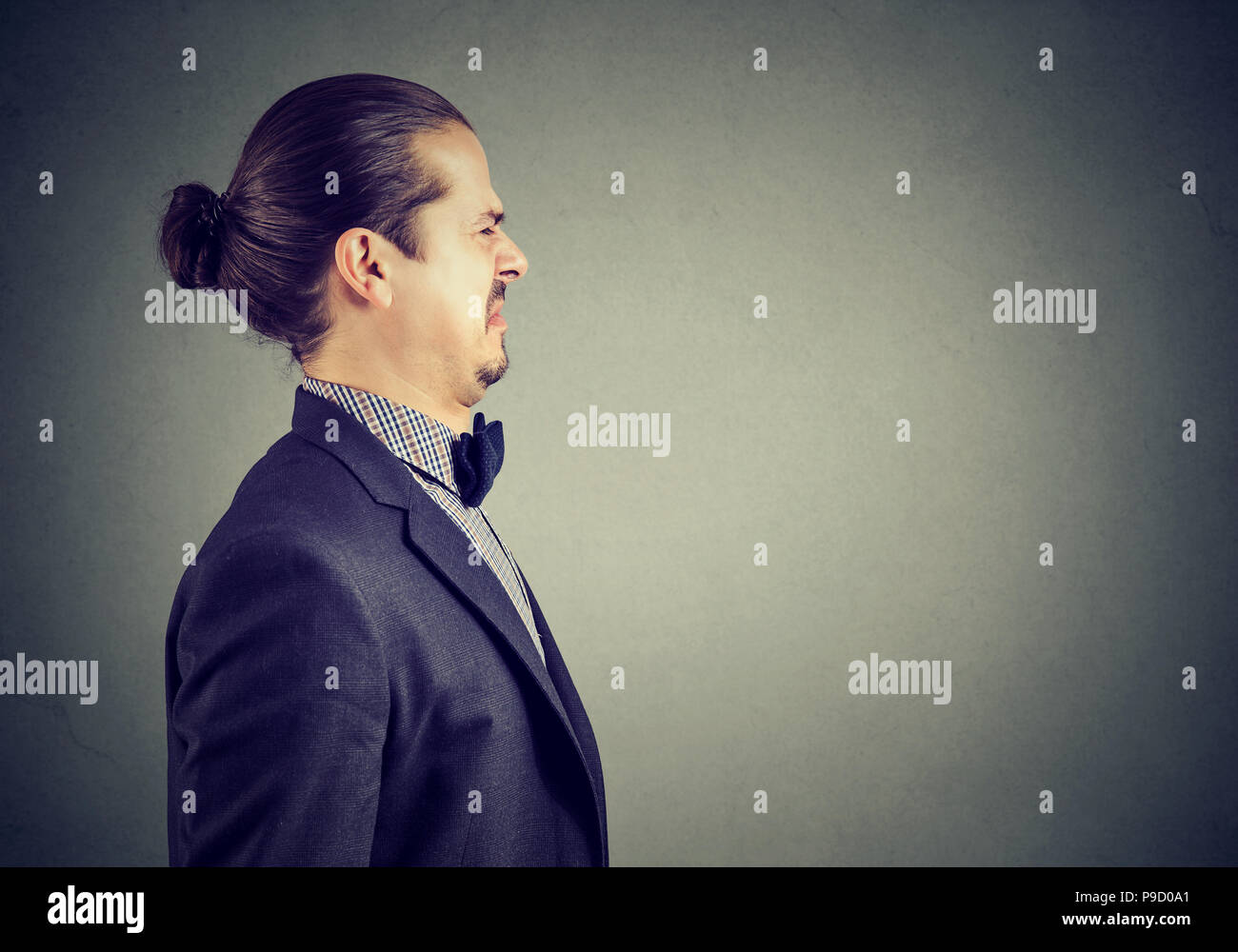 Side portrait of a disgusted young business man Stock Photo