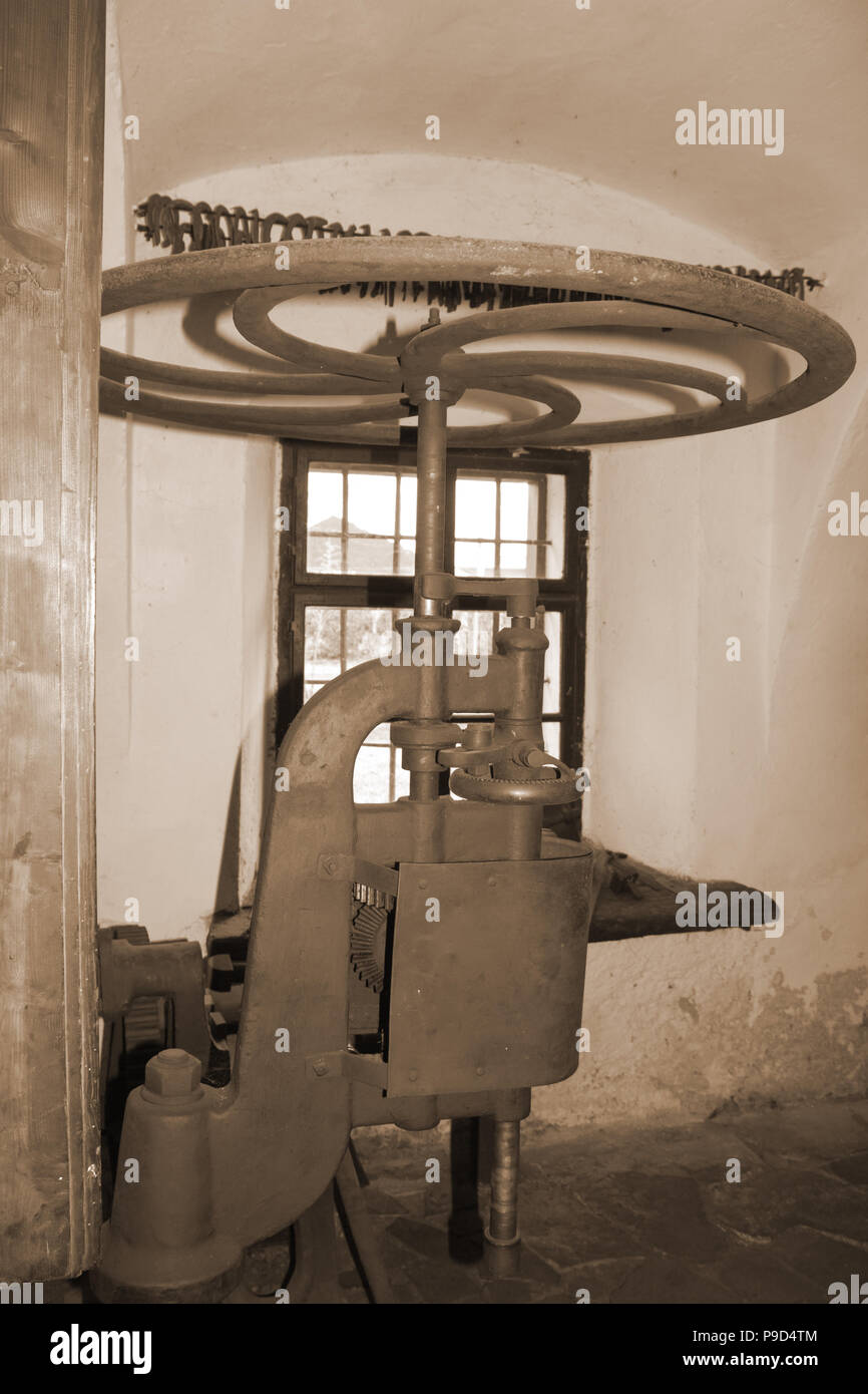 The old machine in the blacksmith in sepia color Stock Photo