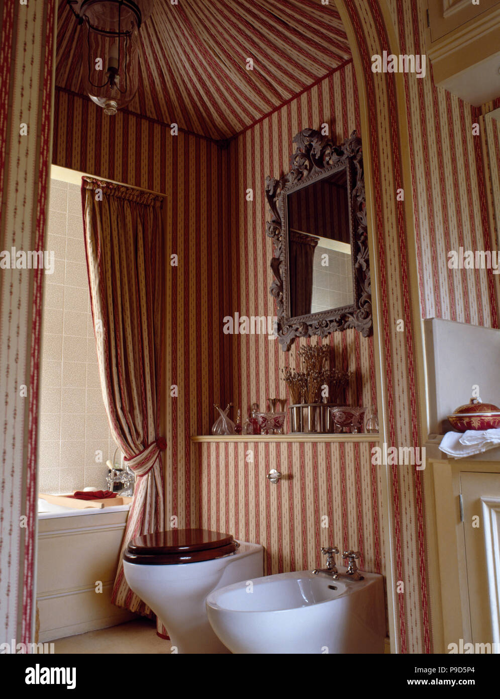 Red Striped Wallpaper And Tented Ceiling In A Nineties Bathroom