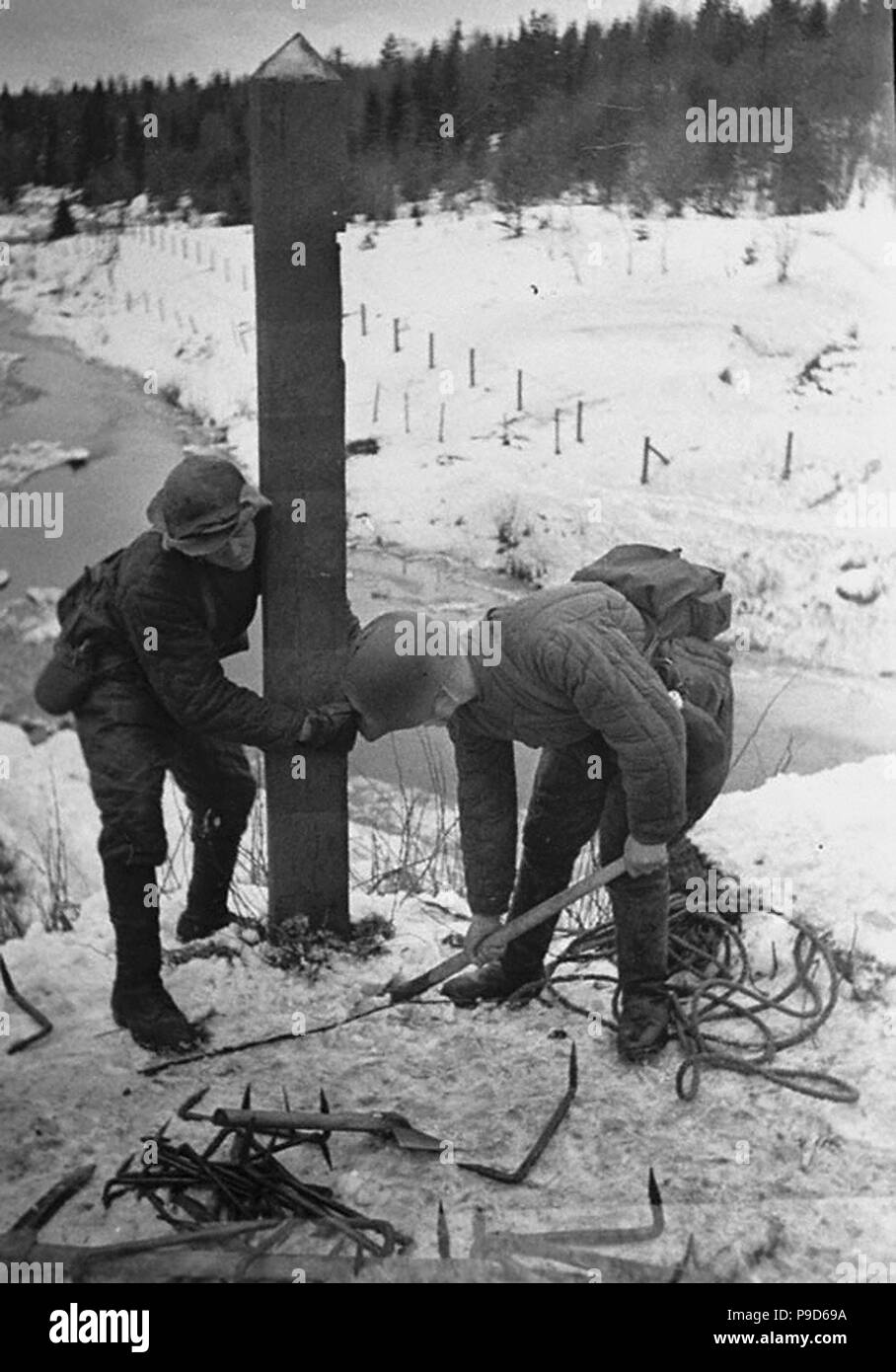 Red Army soldiers removed the border post in Karelia. The Winter War. 1939. Museum: Russian State Film and Photo Archive, Krasnogorsk. Stock Photo