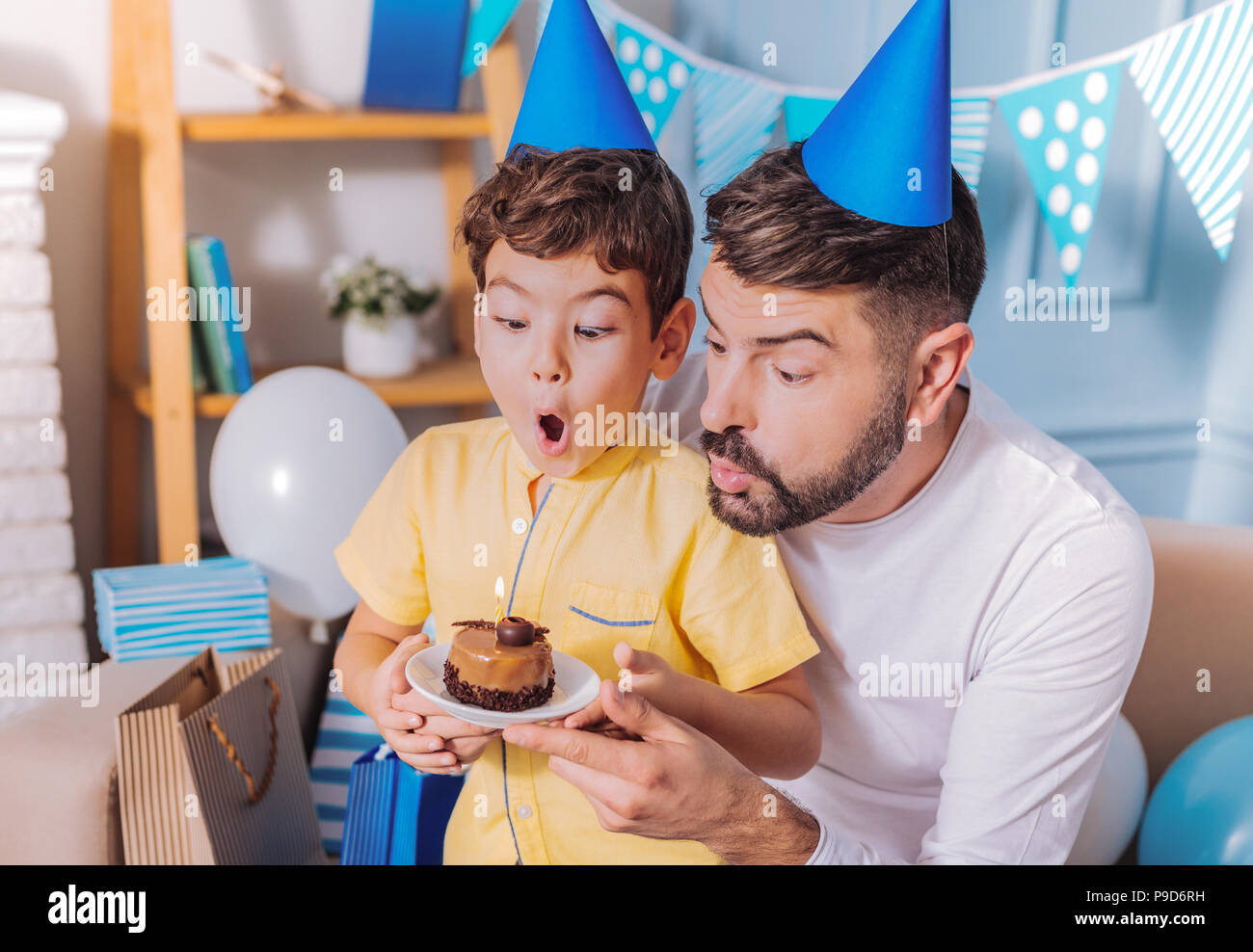 Funny boy going to blow out candle Stock Photo Alamy