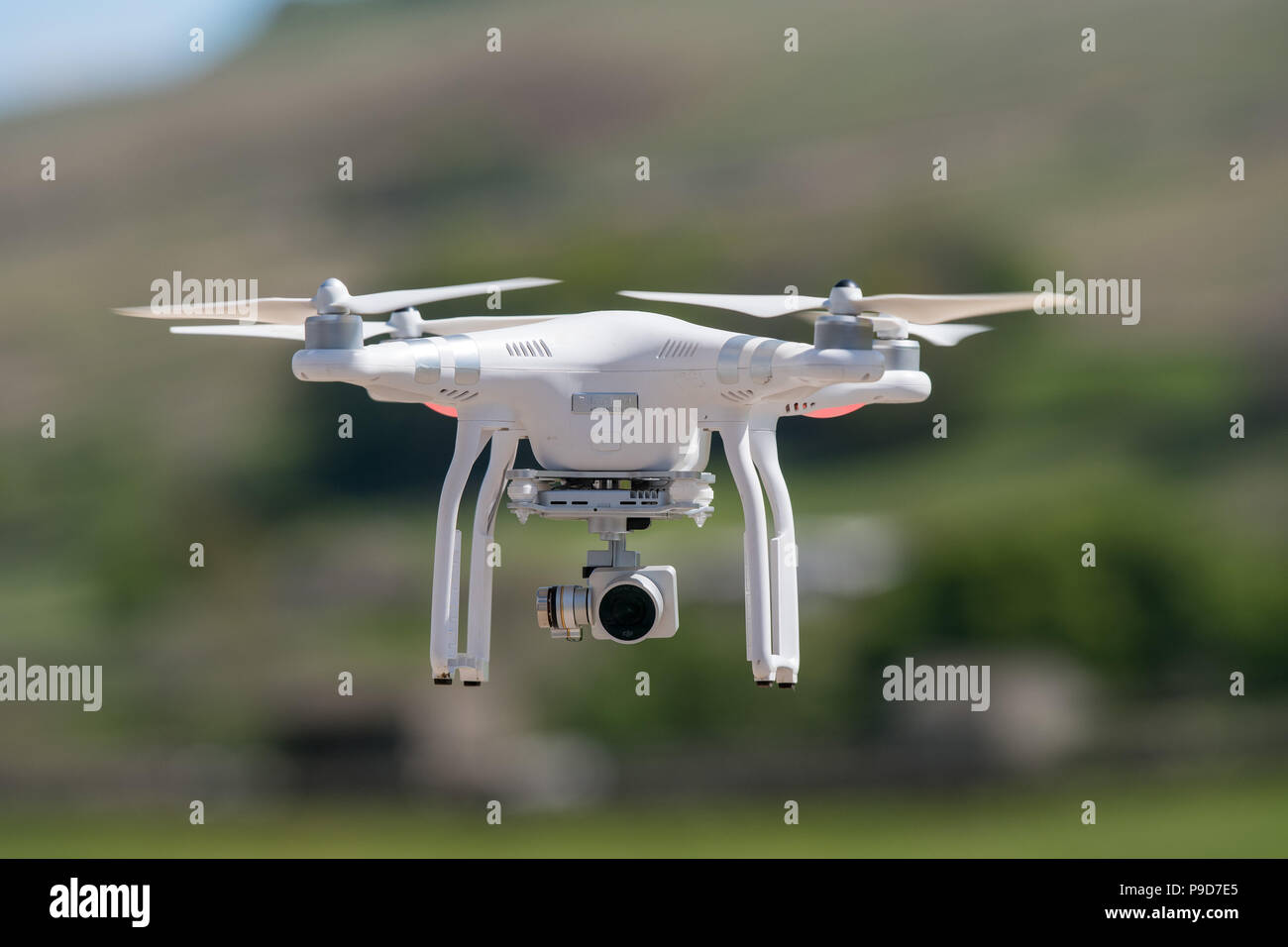 Drone with camera being used in the countryside. Stock Photo