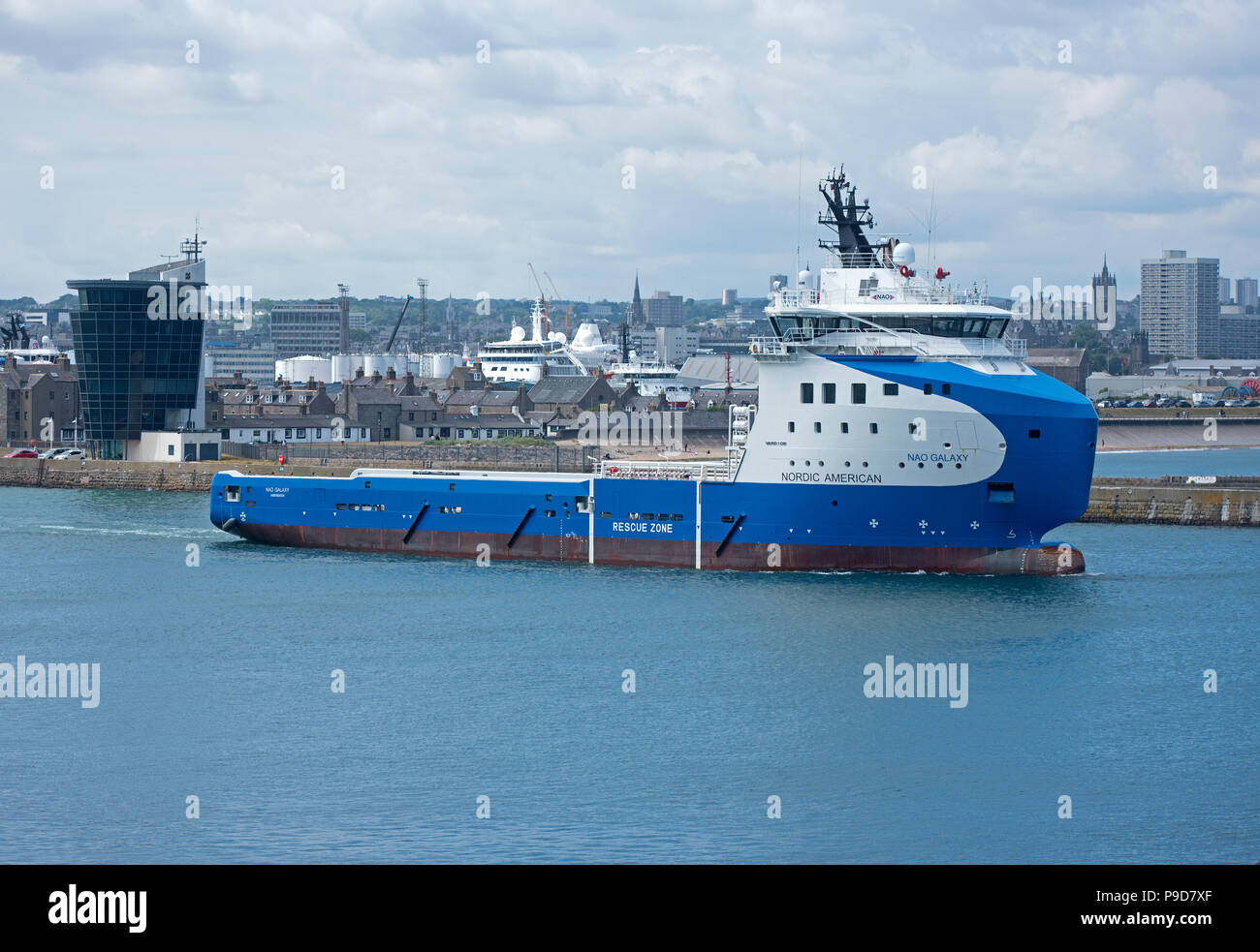 The Nao Galaxy oil platform supply ship heads down the river Dee in Aberdeen Scotland before making it's way across the North Sea. Stock Photo