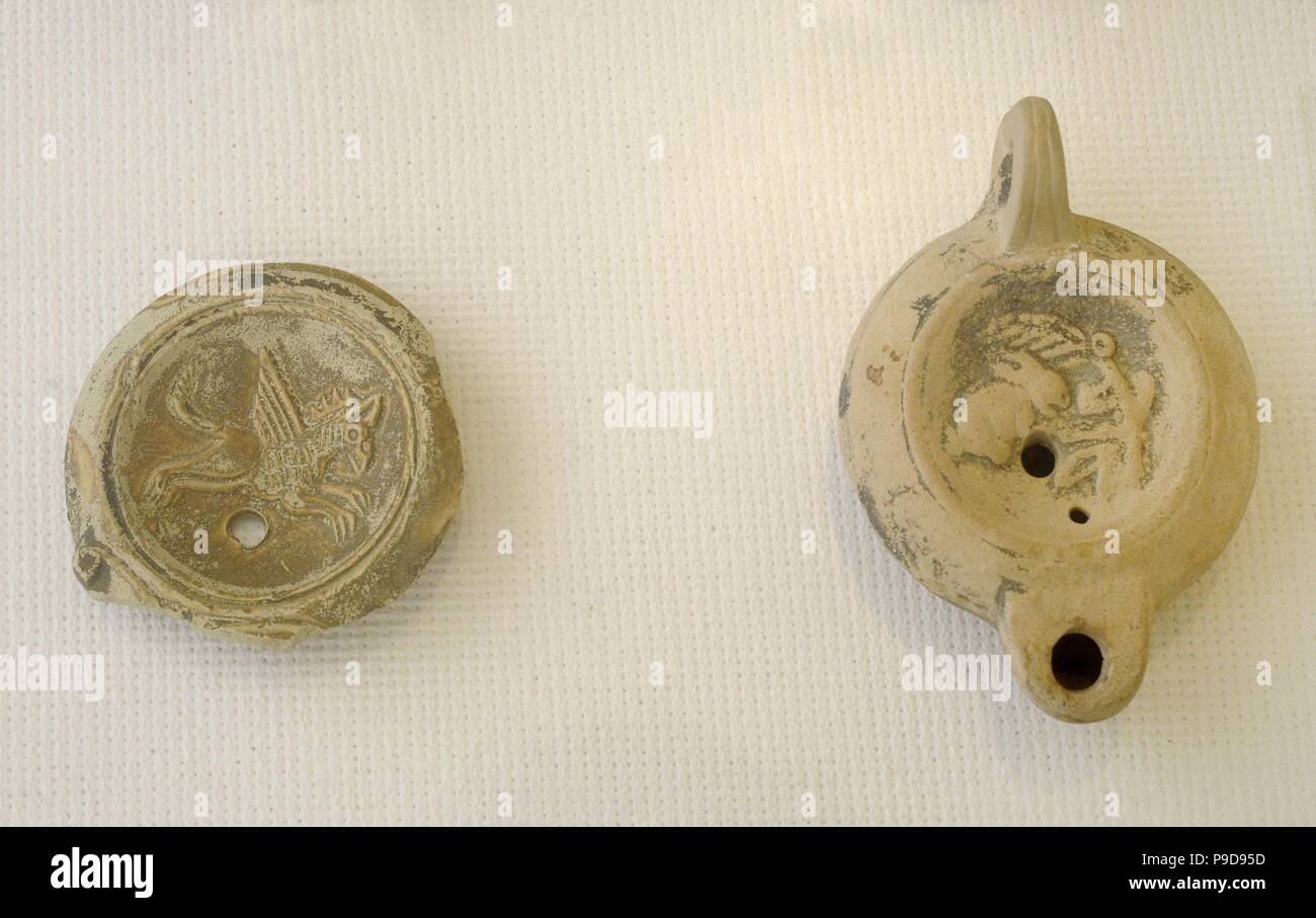 Roman Era. High empire. Terracotta oil lamp. Central disk decorated with reliefs. Spain.n. National Archaeological Museum. Tarragona. Catalonia, Spain. Stock Photo