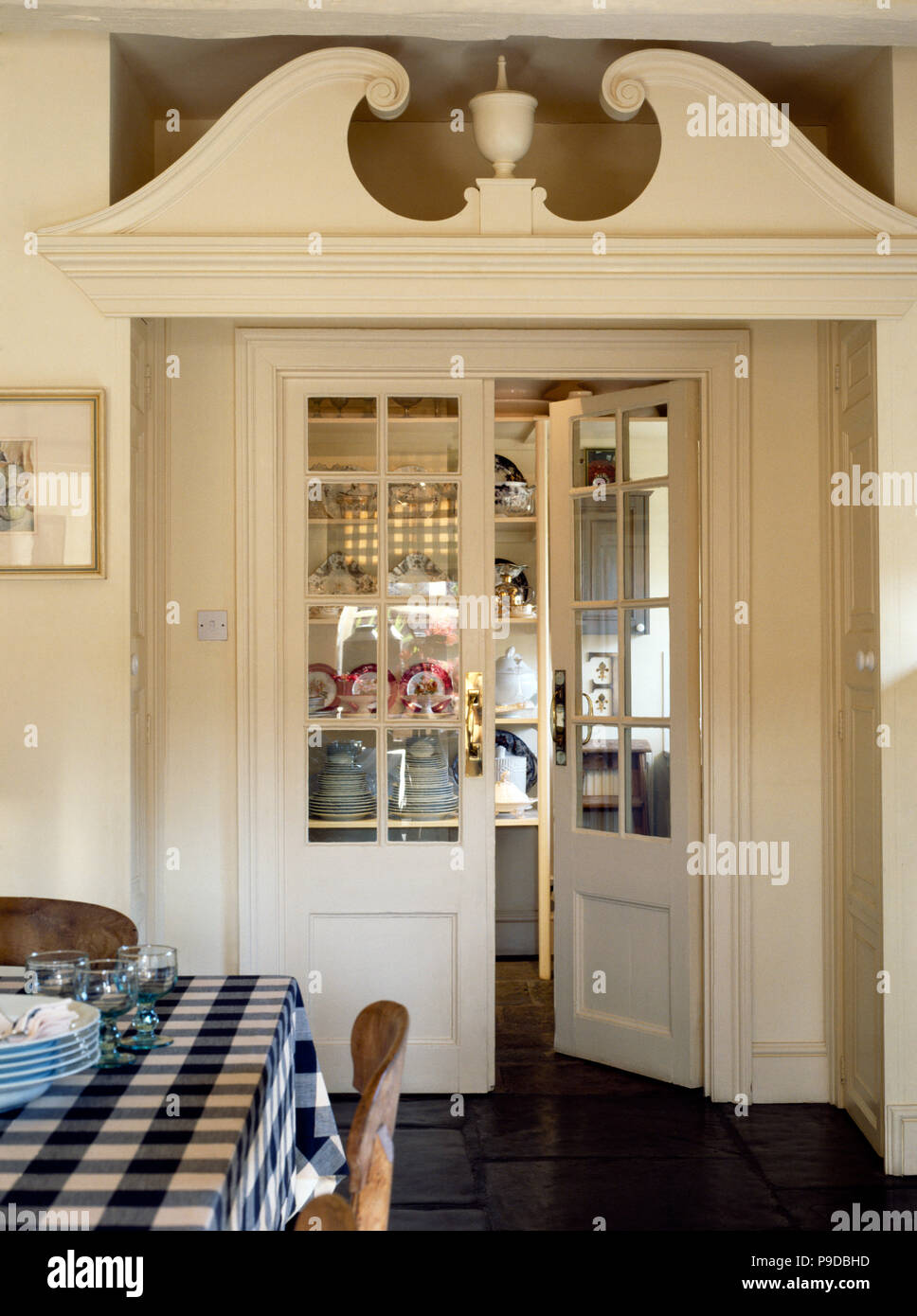 Painted Ornate Pediment Above Half Glazed Cream Doors To The