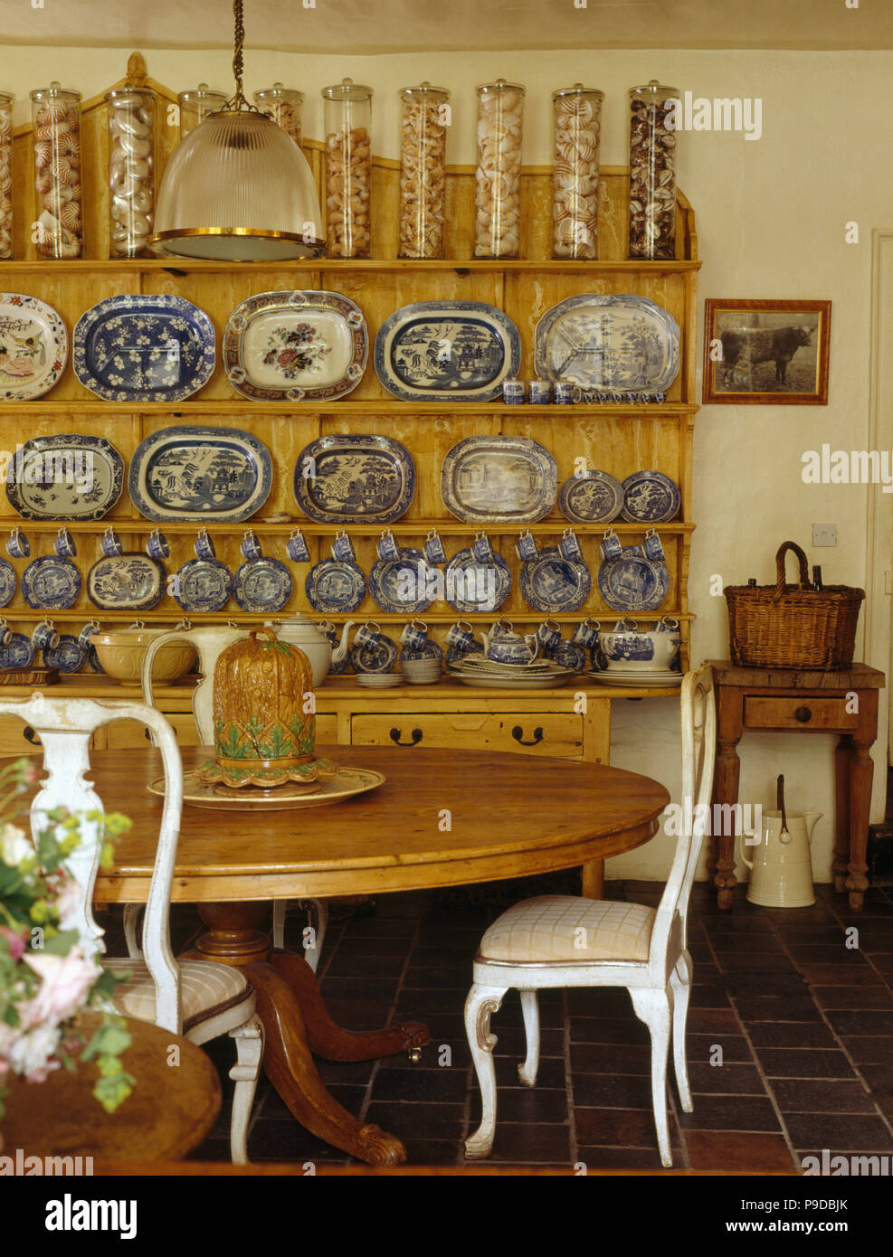 Glass Storage Jars And Blue Plate Collection On Dresser In