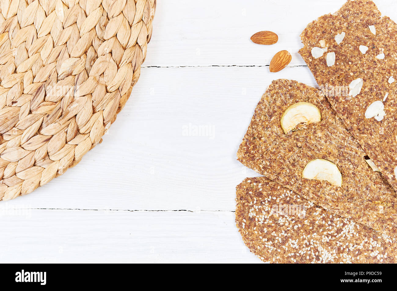 Bread with flaxseeds and almonds on a white wooden background. Useful dietary raw bread vegan breakfast without yeast Stock Photo