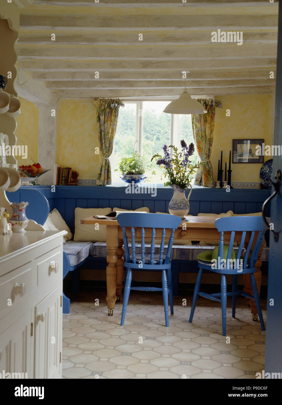 Bright Blue Chiars At Pine Table In Pale Yellow Cottage Living