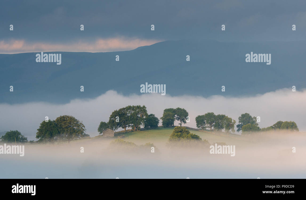 Another glorious day bekons after the early morning mist in the Yorkshire Dale National Park around Semerwater, Wensleydale. Stock Photo