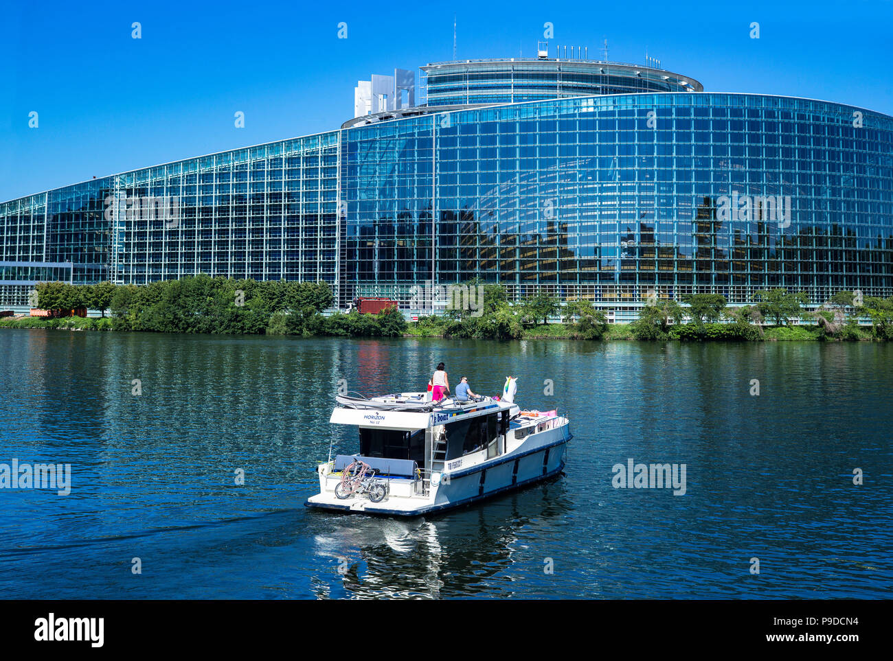 Strasbourg, pleasure boat cruising on Ill river, Louise Weiss building, EU, European Parliament, Alsace, France, Europe, Stock Photo