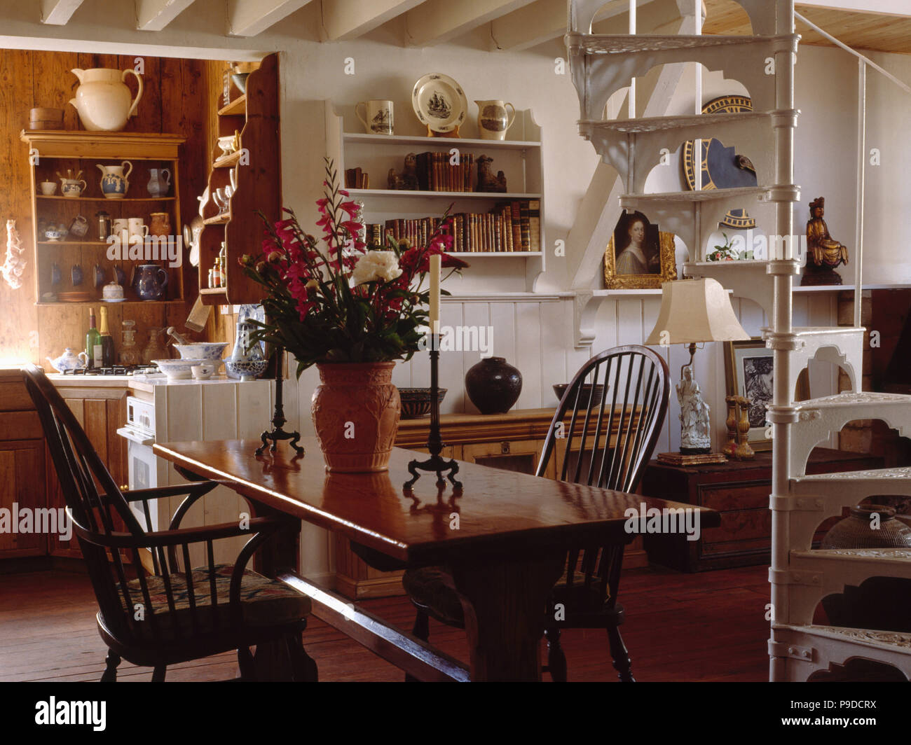 White metal spiral staircase in openplan cottage hall dining room Stock ...