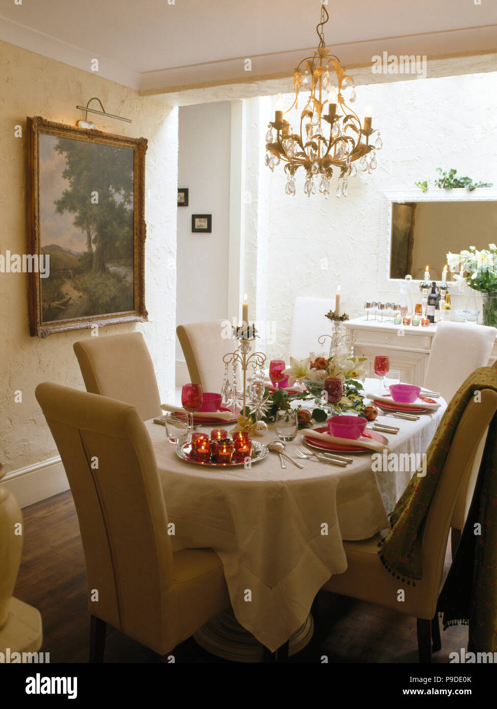 Cream Upholstered Chairs At Table With Linen Cloth Set For Dinner In Traditional Dining Room Stock Photo Alamy