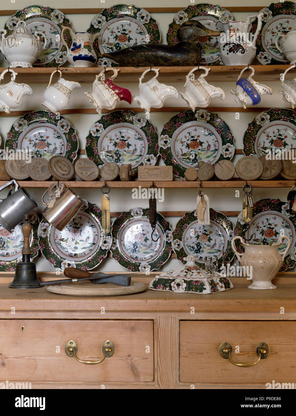 Collection of vintage crockery on an old pine dresser Stock Photo