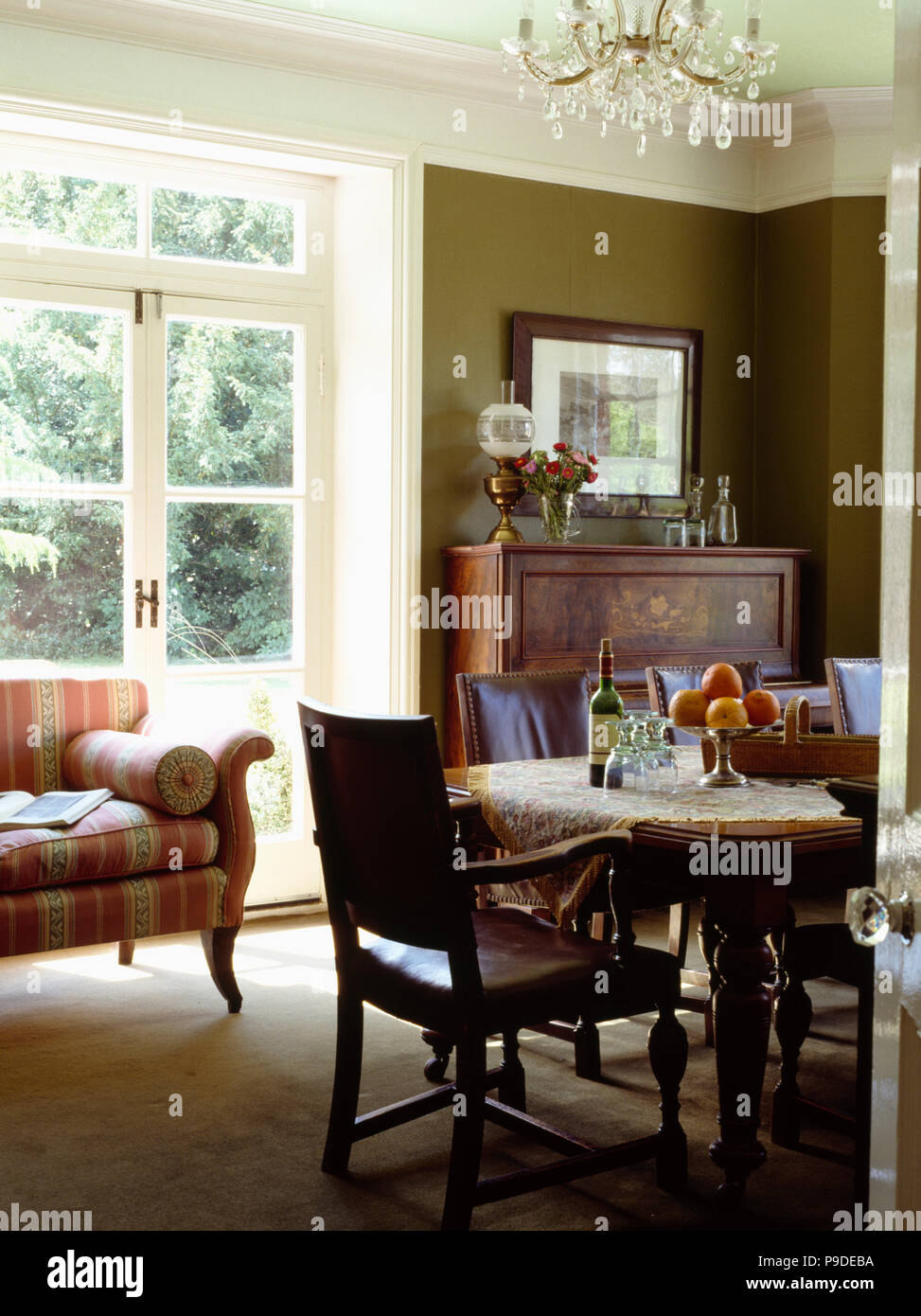 Old Leather Backed Chairs And Traditional Table In Olive